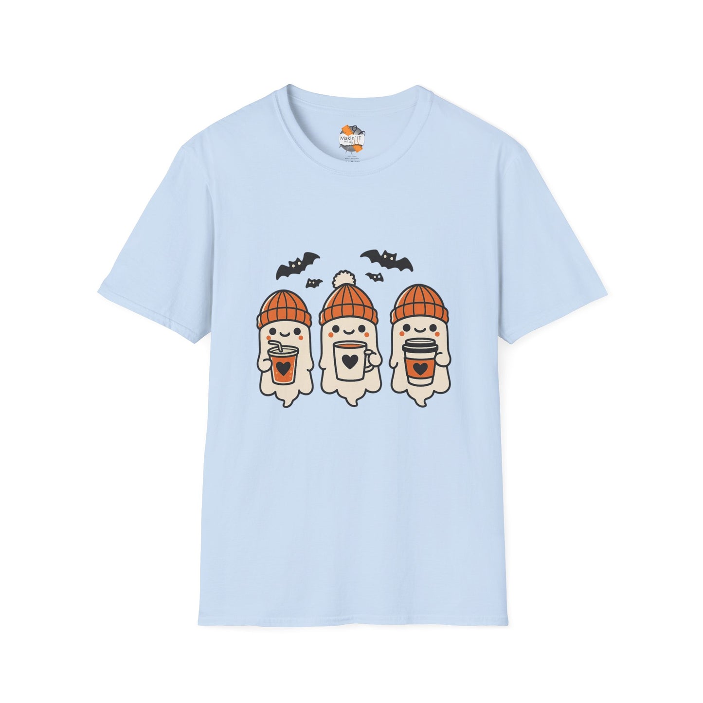 Light blue unisex t-shirt featuring three cute baby ghosts in orange knitted beanies holding drinks with bats overhead – cozy Halloween design by Makin’ It By Lady Ev