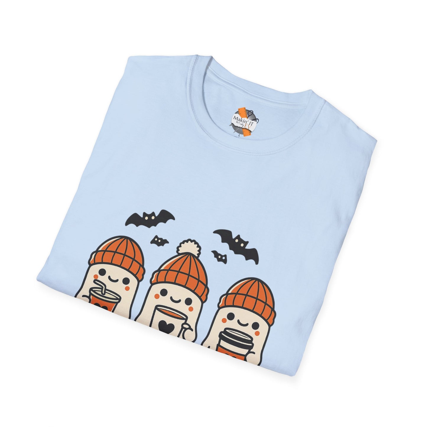 Folded light blue Halloween t-shirt with three cute ghosts in orange beanies holding drinks, by Makin’ It By Lady Ev.