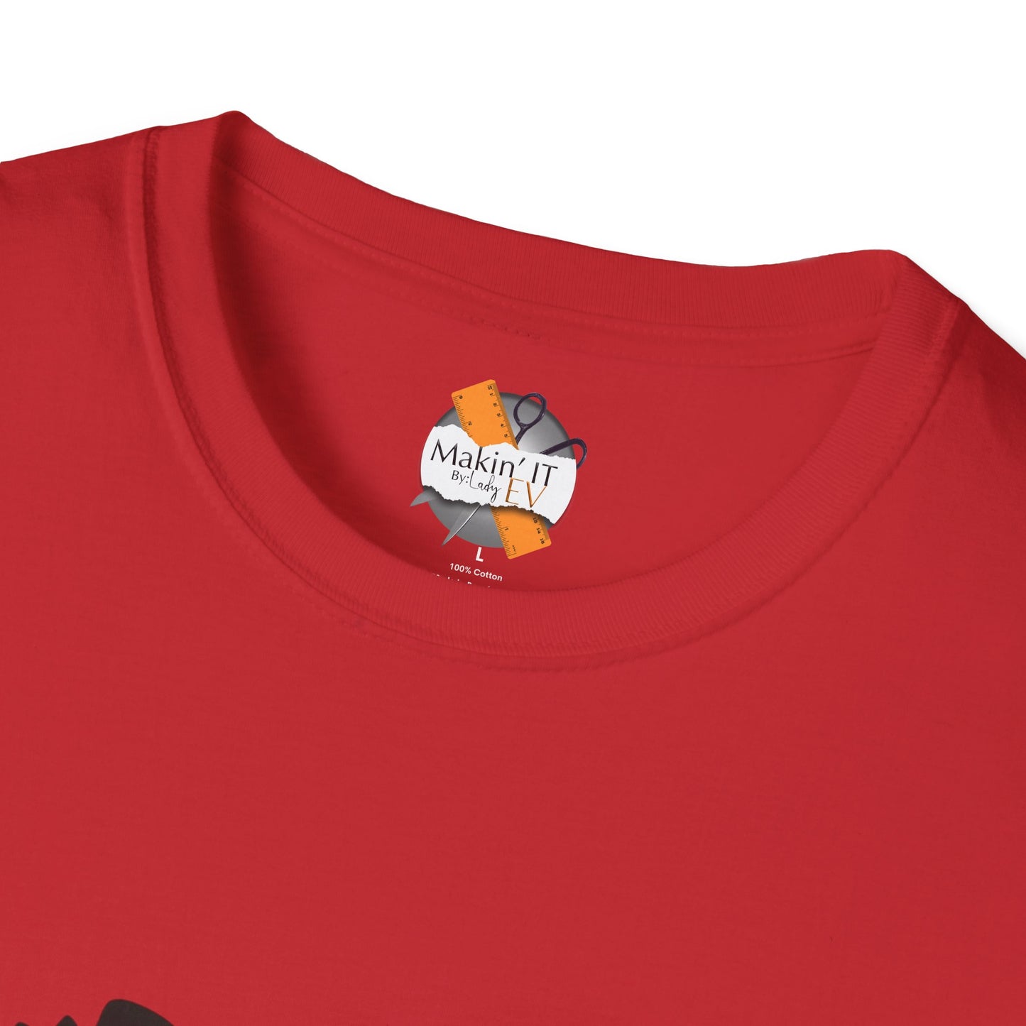 Close-up of red cotton t-shirt collar with Makin’ It By Lady Ev custom neck tag and size label.