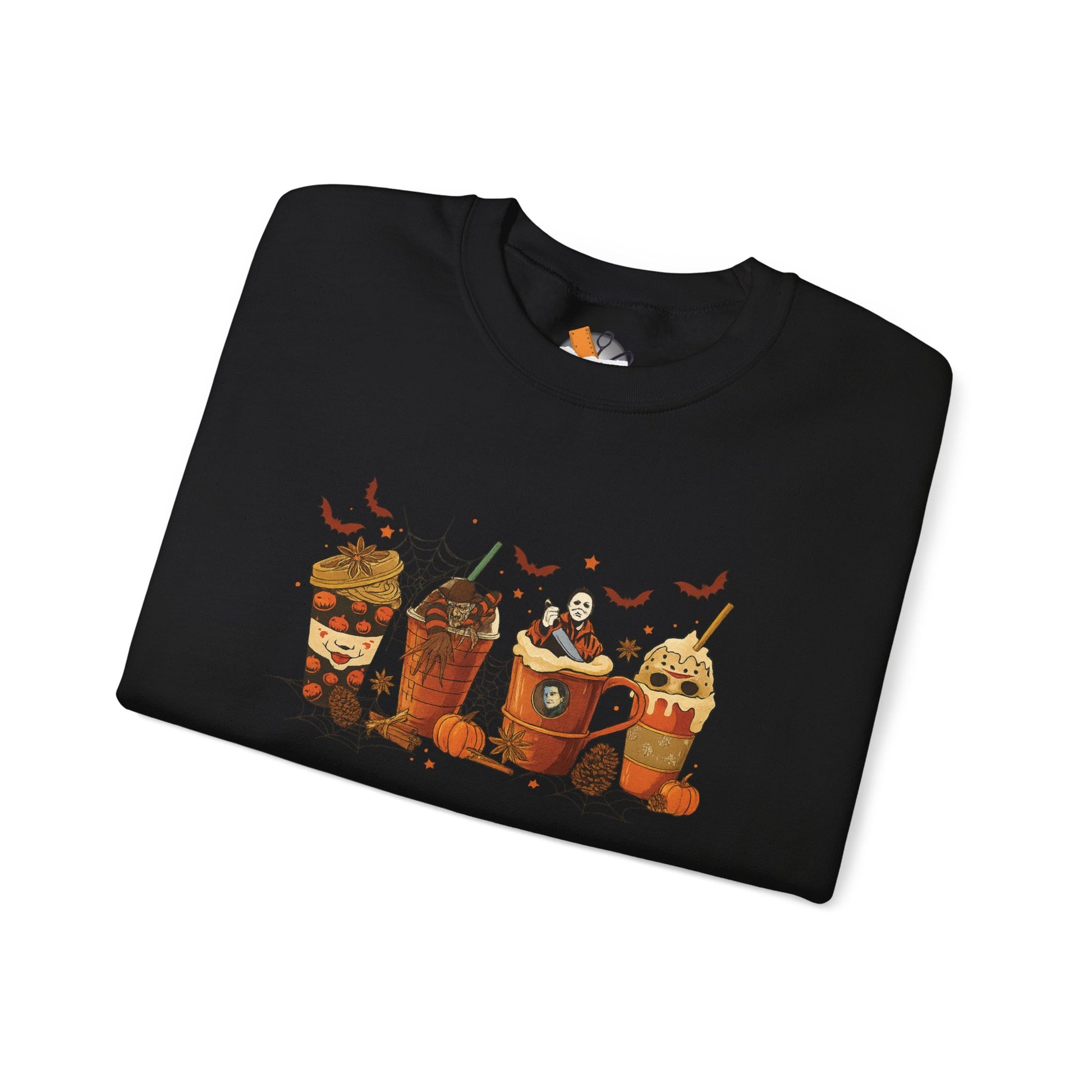 Folded black Gildan 18000 crewneck sweatshirt with Halloween horror coffee drinks graphic featuring spooky characters, pumpkins, and bats.