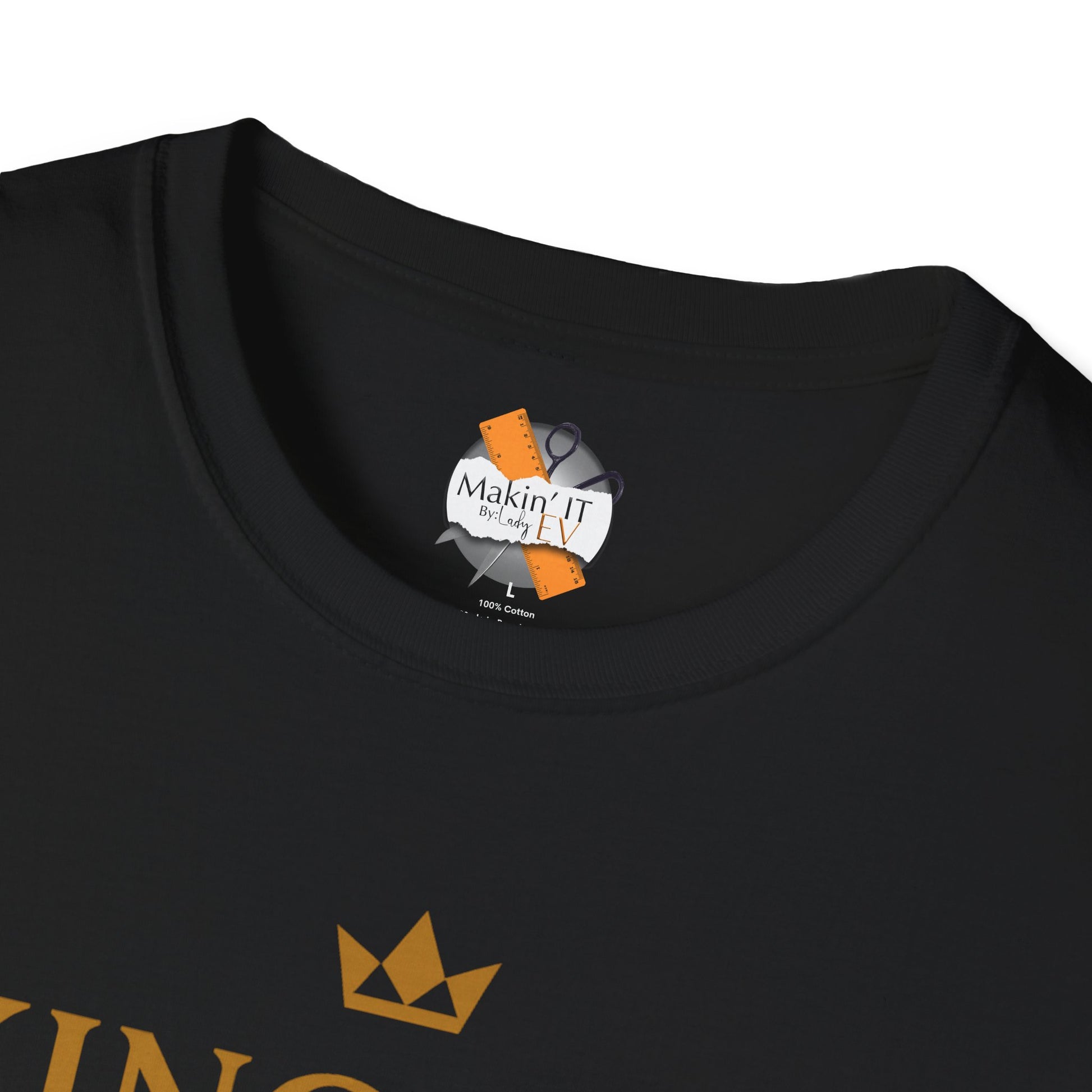 Close-up of black King Kev t-shirt showing Makin’ It By Lady Ev neck tag with gold crown logo design
