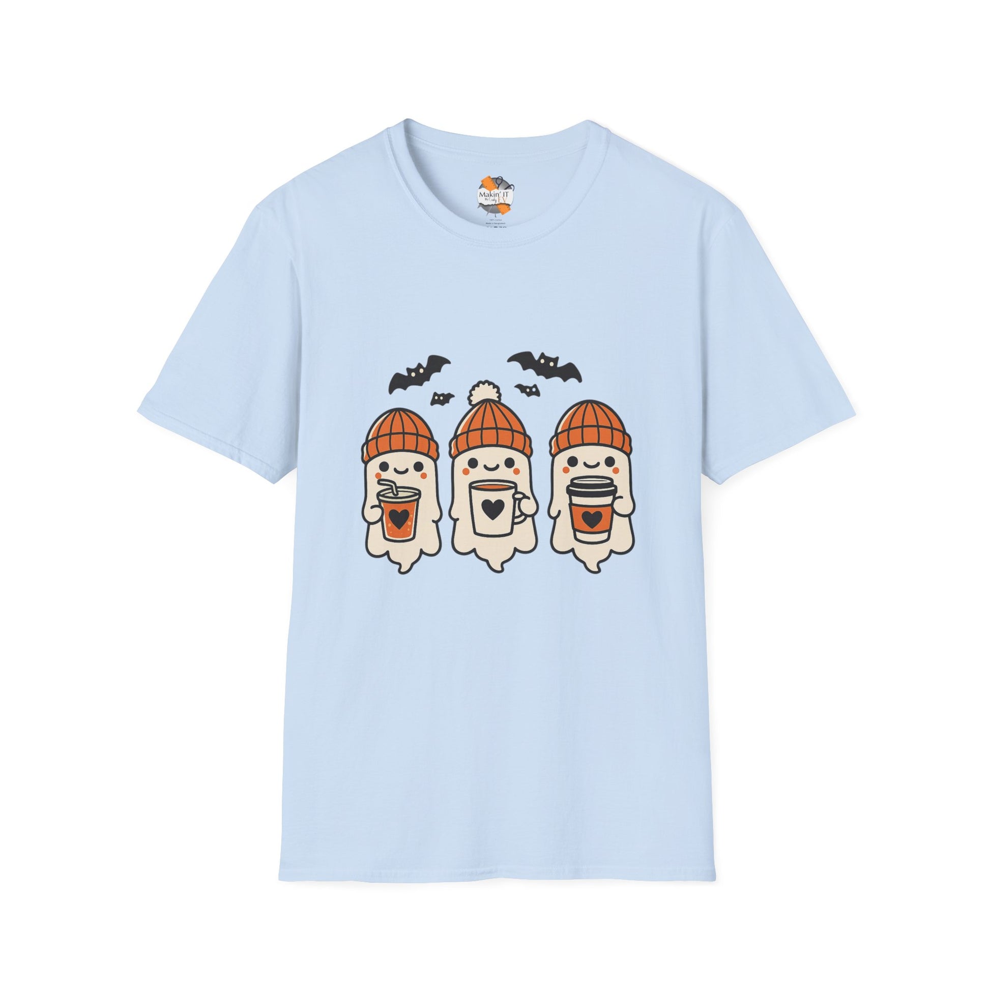 Light blue unisex t-shirt featuring three cute baby ghosts in orange knitted beanies holding drinks with bats overhead – cozy Halloween design by Makin’ It By Lady Ev