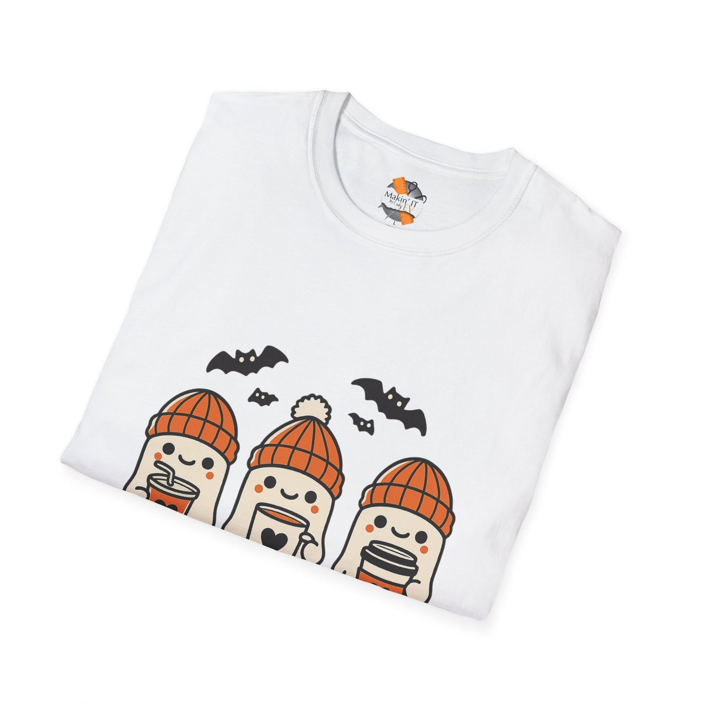 Folded white unisex Halloween shirt featuring three cute ghosts in orange beanies sipping drinks, with bats above – by Makin’ It By Lady Ev
