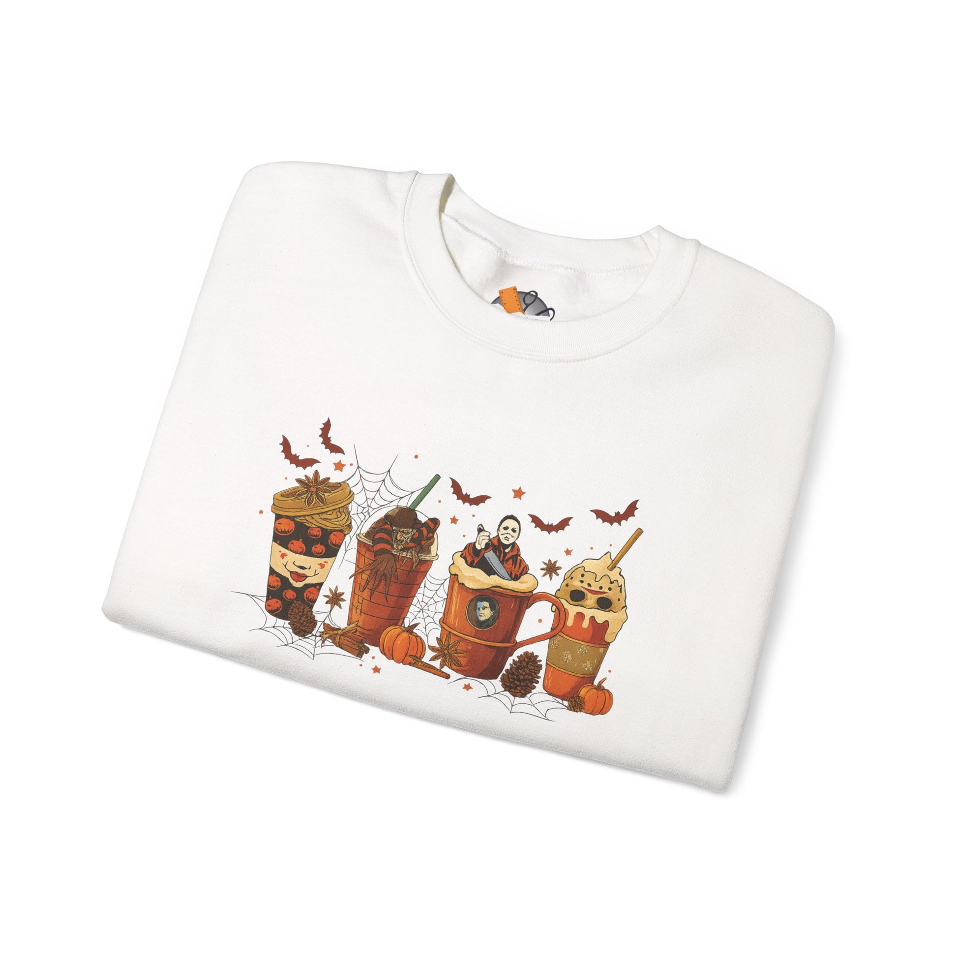 Folded white crewneck sweatshirt with Halloween horror drinks design showing spooky coffee cups and bats.