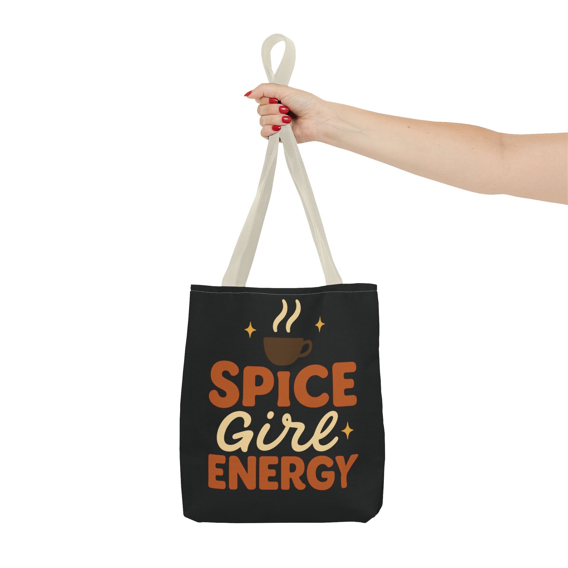 Beige-handled black “Spice Girl Energy” tote bag held in hand — stylish coffee-lover tote bag for fall outfits and daily errands.