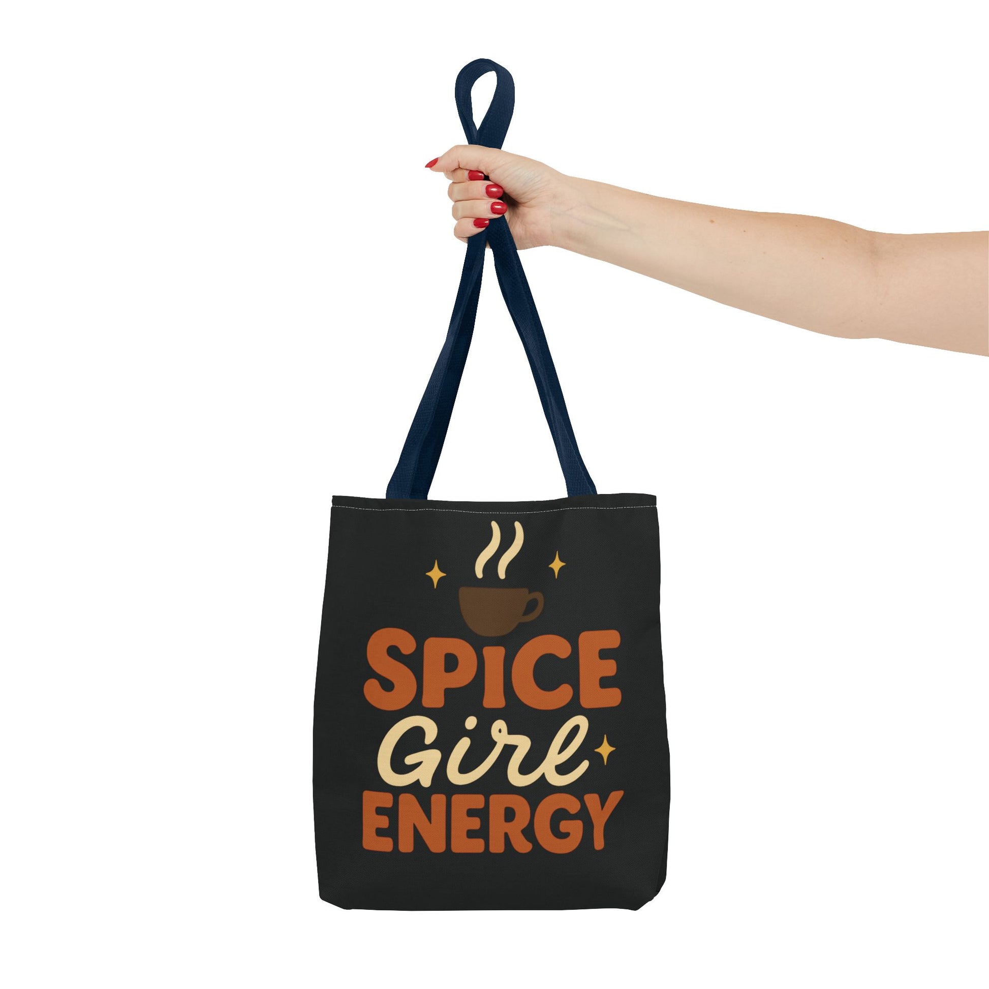 Navy-handled black “Spice Girl Energy” tote bag held in hand — cozy coffee aesthetic tote for stylish fall days.