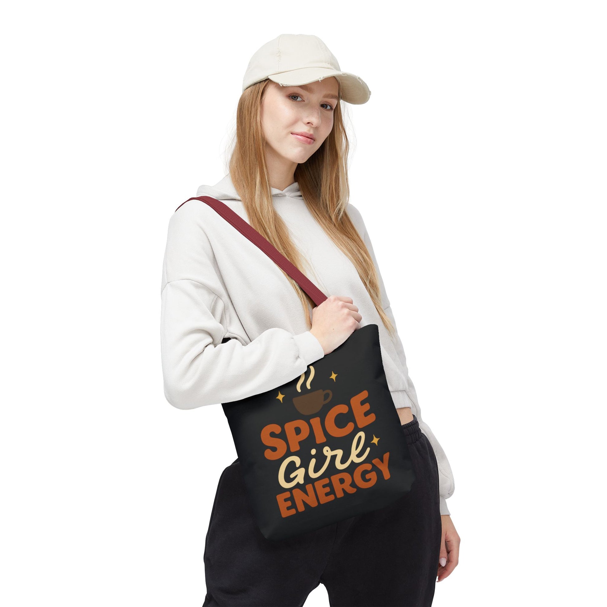Woman wearing black “Spice Girl Energy” tote bag with red handles — stylish fall tote for cozy coffee runs and casual outfits.