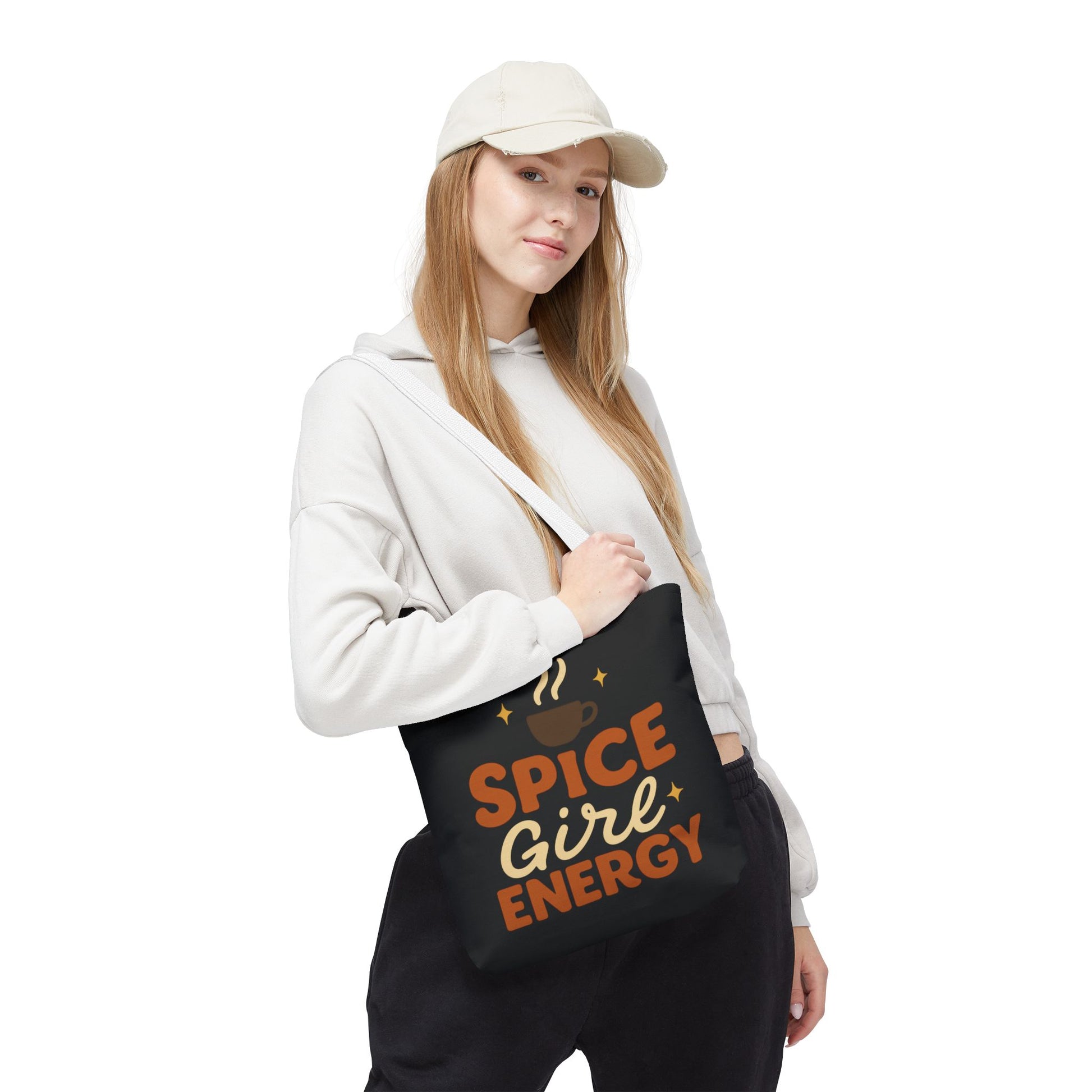Model wearing black “Spice Girl Energy” tote bag with white straps — chic everyday tote for cozy weather and coffee aesthetics.