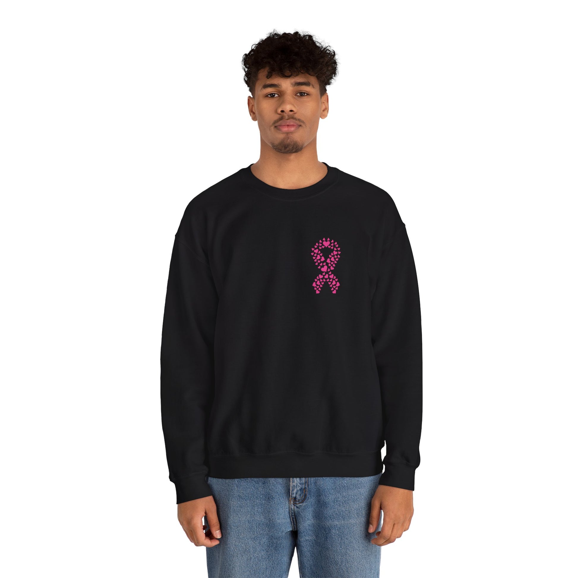 Man wearing black breast cancer awareness crewneck sweatshirt with pink heart ribbon design, Makin’ It by Lady Ev.