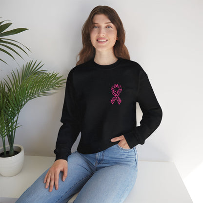 Woman seated in black breast cancer awareness crewneck sweatshirt with pink heart ribbon graphic, Makin’ It by Lady Ev.