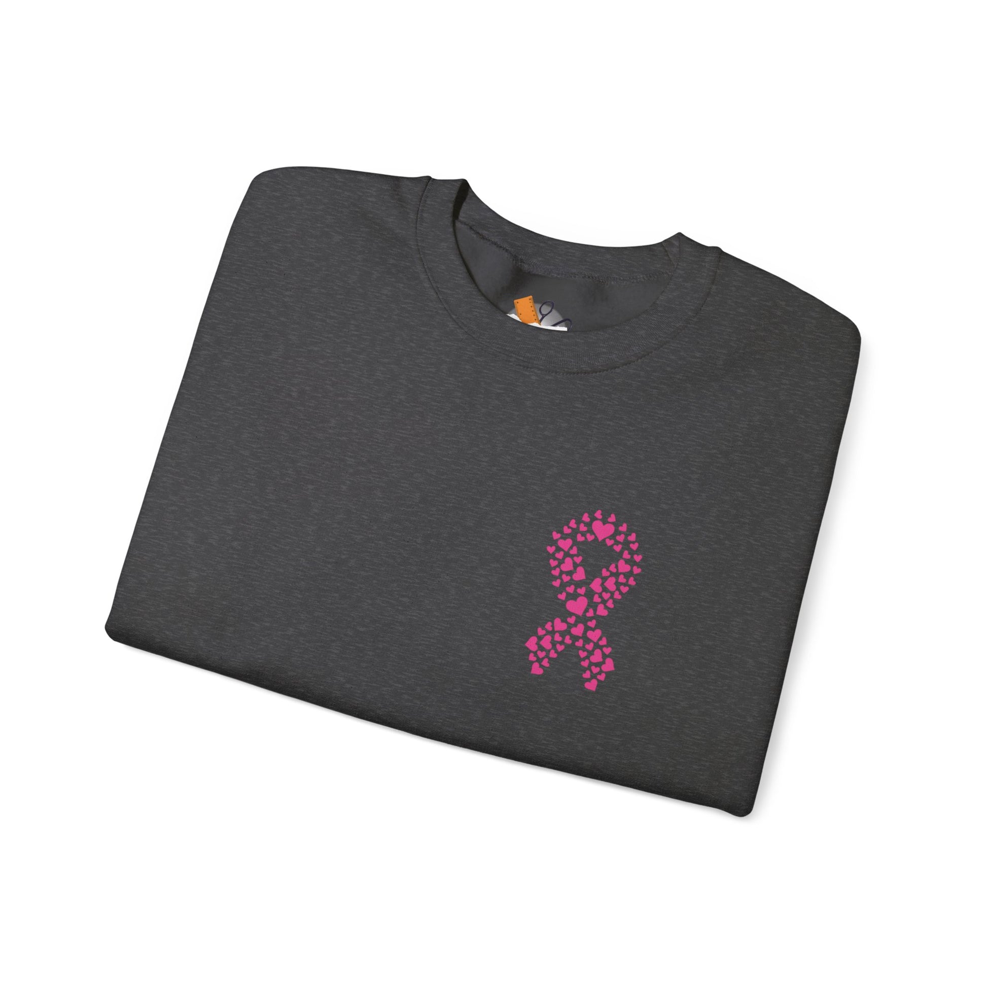 Folded charcoal gray crewneck sweatshirt with pink heart ribbon design for breast cancer awareness, Makin’ It by Lady Ev.