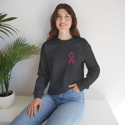 Woman seated in charcoal gray breast cancer awareness crewneck sweatshirt with heart-shaped pink ribbon, Makin’ It by Lady Ev.