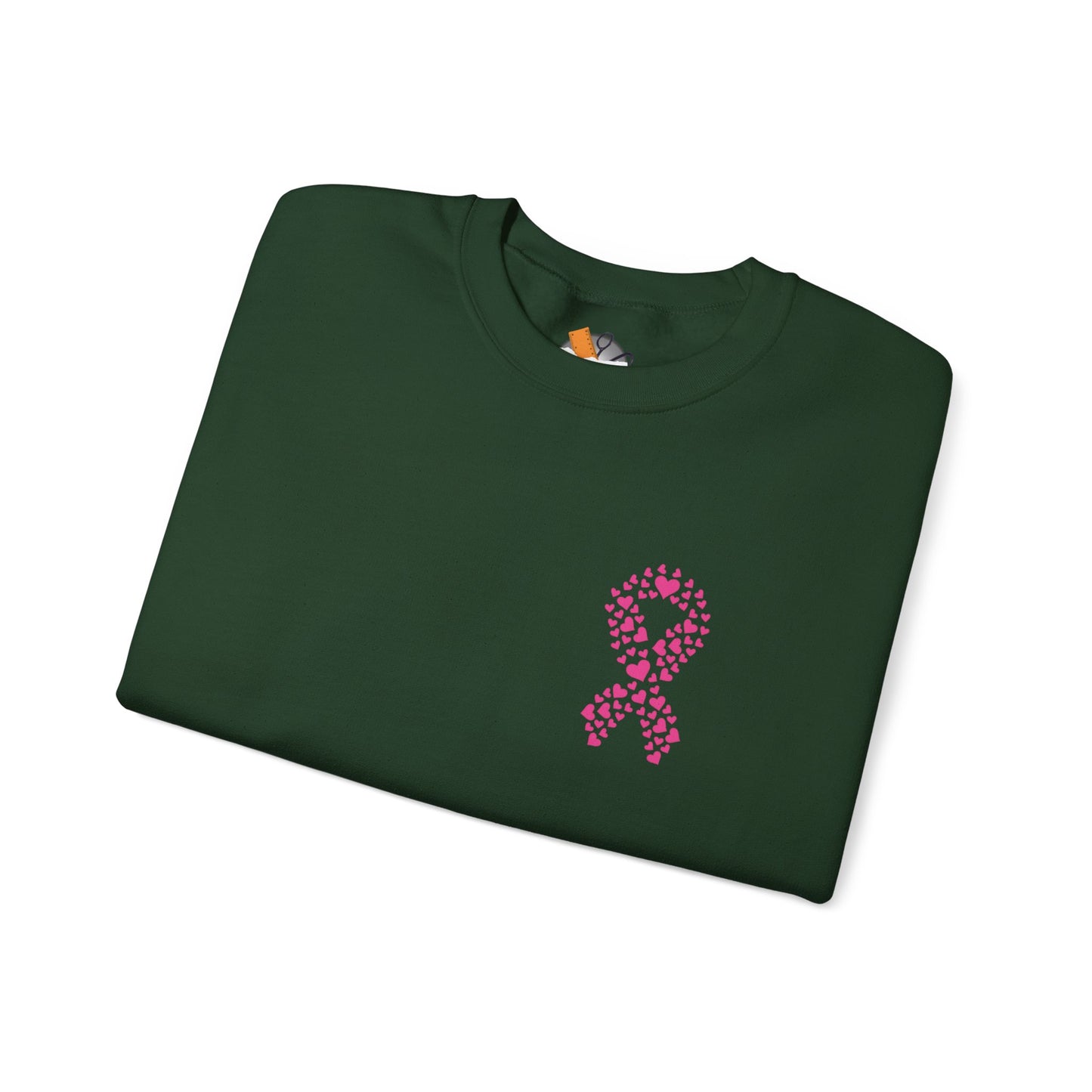 Folded forest-green crewneck sweatshirt with pink ribbon of hearts design promoting breast cancer awareness, Makin’ It by Lady Ev.