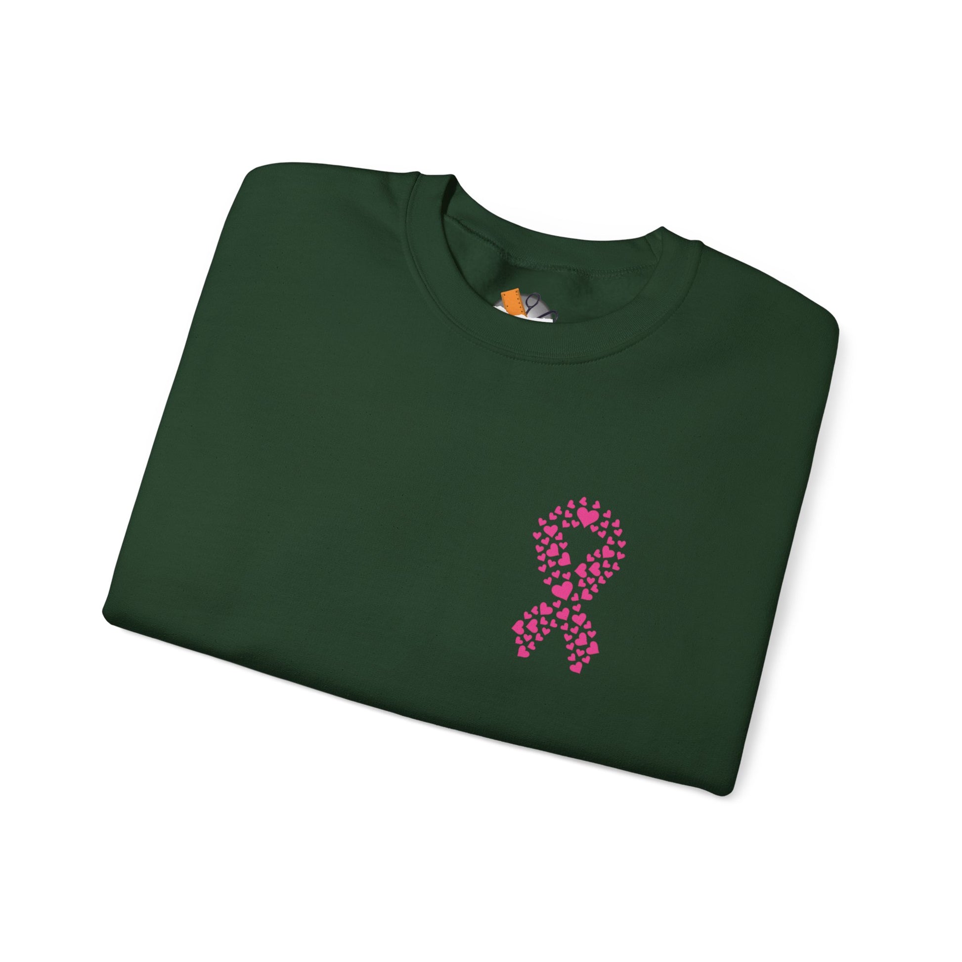 Folded forest-green crewneck sweatshirt with pink ribbon of hearts design promoting breast cancer awareness, Makin’ It by Lady Ev.