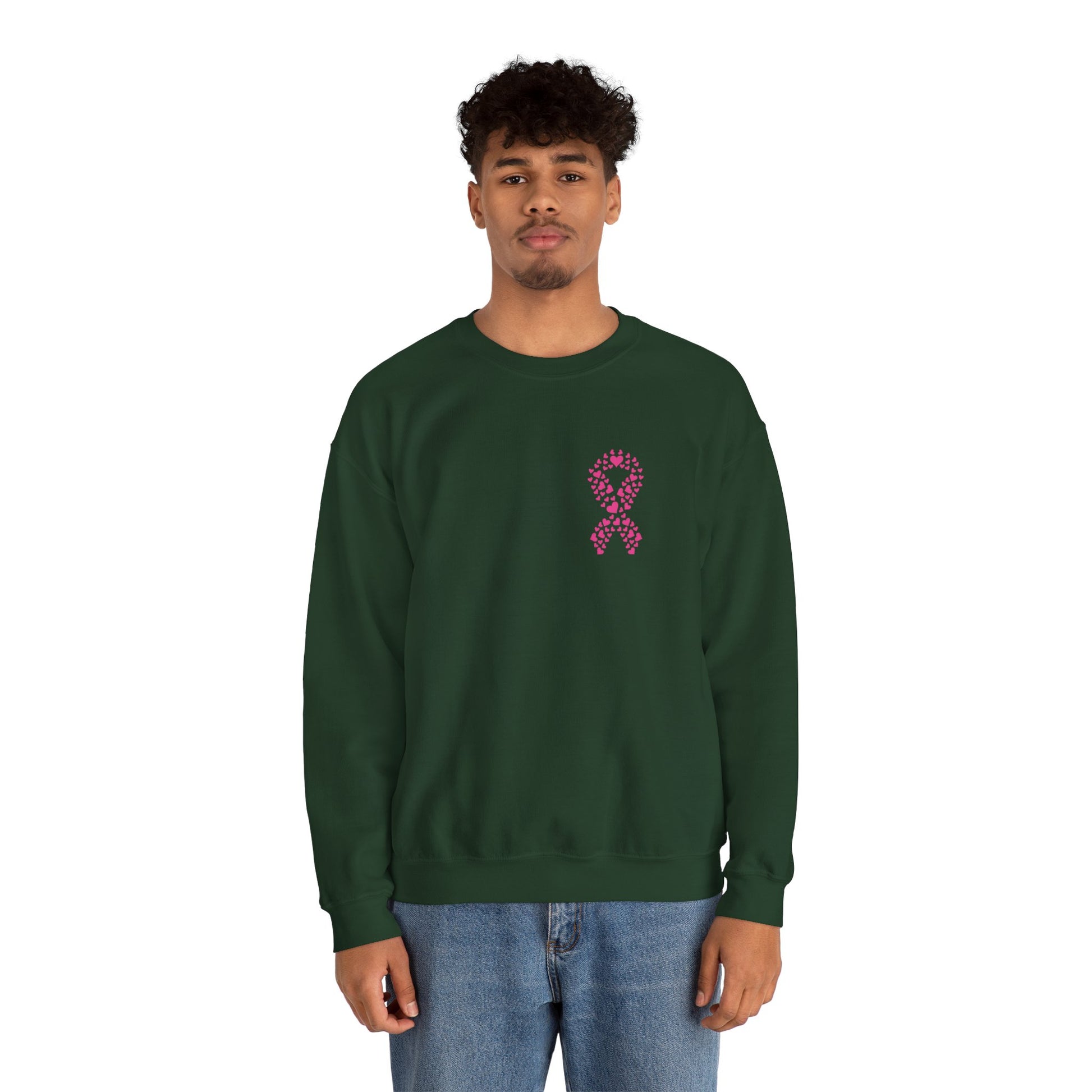 Man wearing forest-green breast cancer awareness crewneck sweatshirt featuring pink heart-shaped ribbon, Makin’ It by Lady Ev.