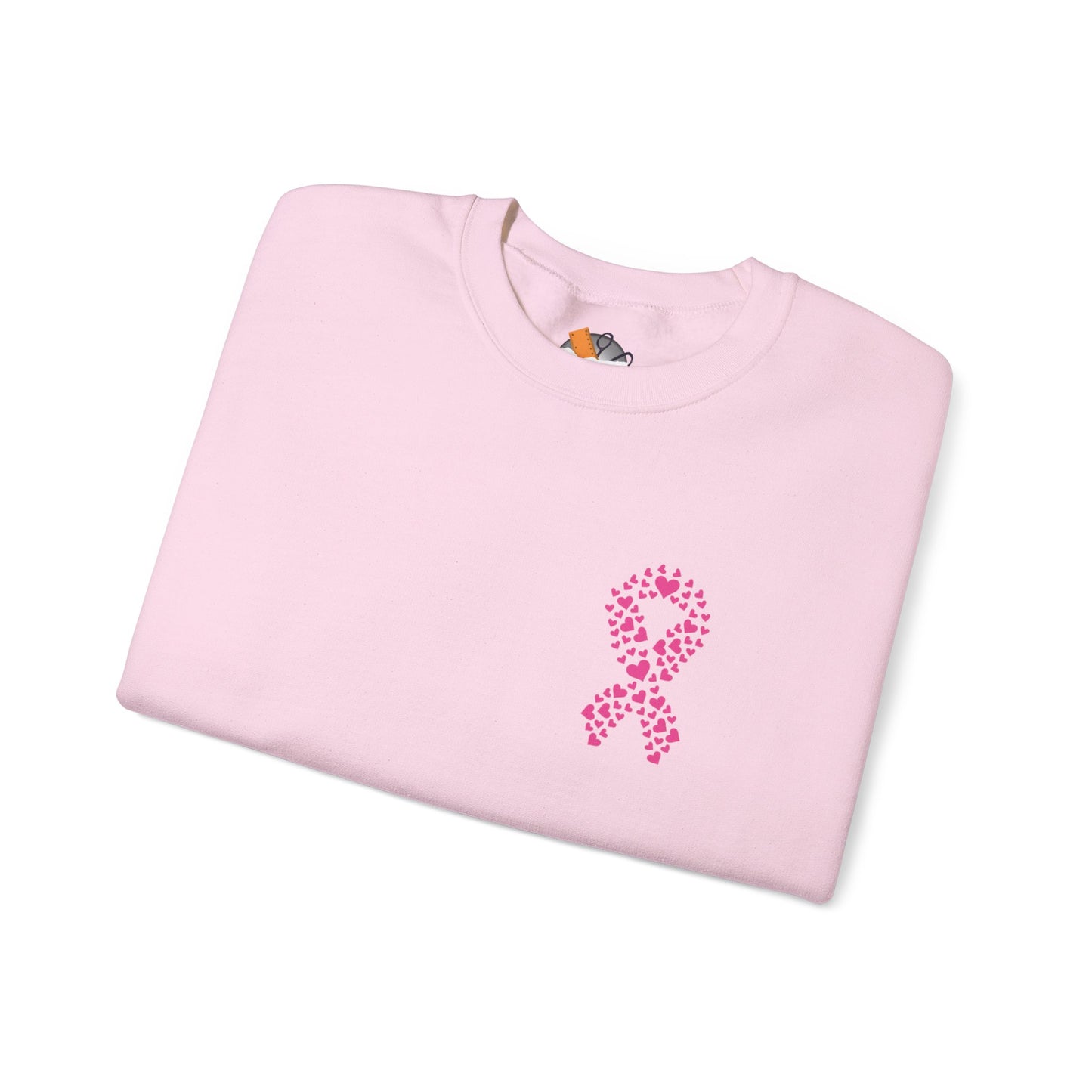 Folded light pink crewneck sweatshirt with heart-shaped pink ribbon design for breast cancer awareness, Makin’ It by Lady Ev