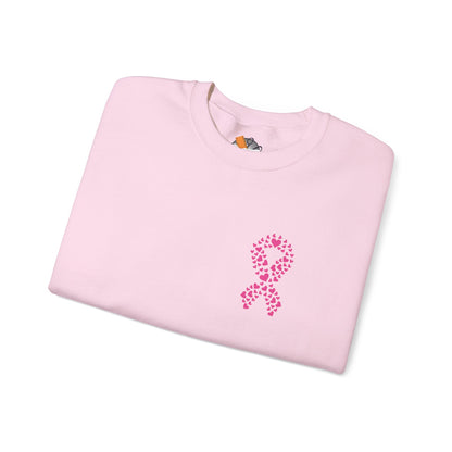 Folded light pink crewneck sweatshirt with heart-shaped pink ribbon design for breast cancer awareness, Makin’ It by Lady Ev
