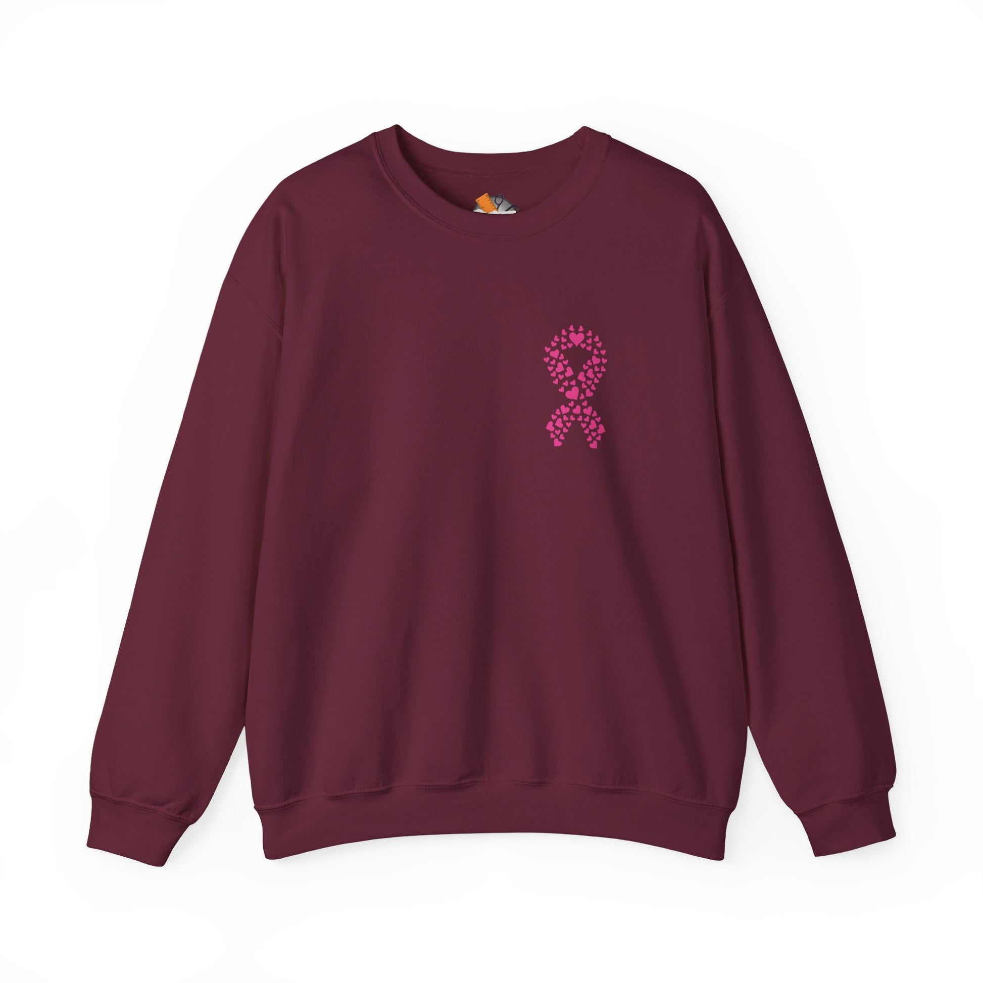 Maroon crewneck sweatshirt featuring pink heart ribbon graphic for breast cancer awareness, Makin’ It by Lady Ev.