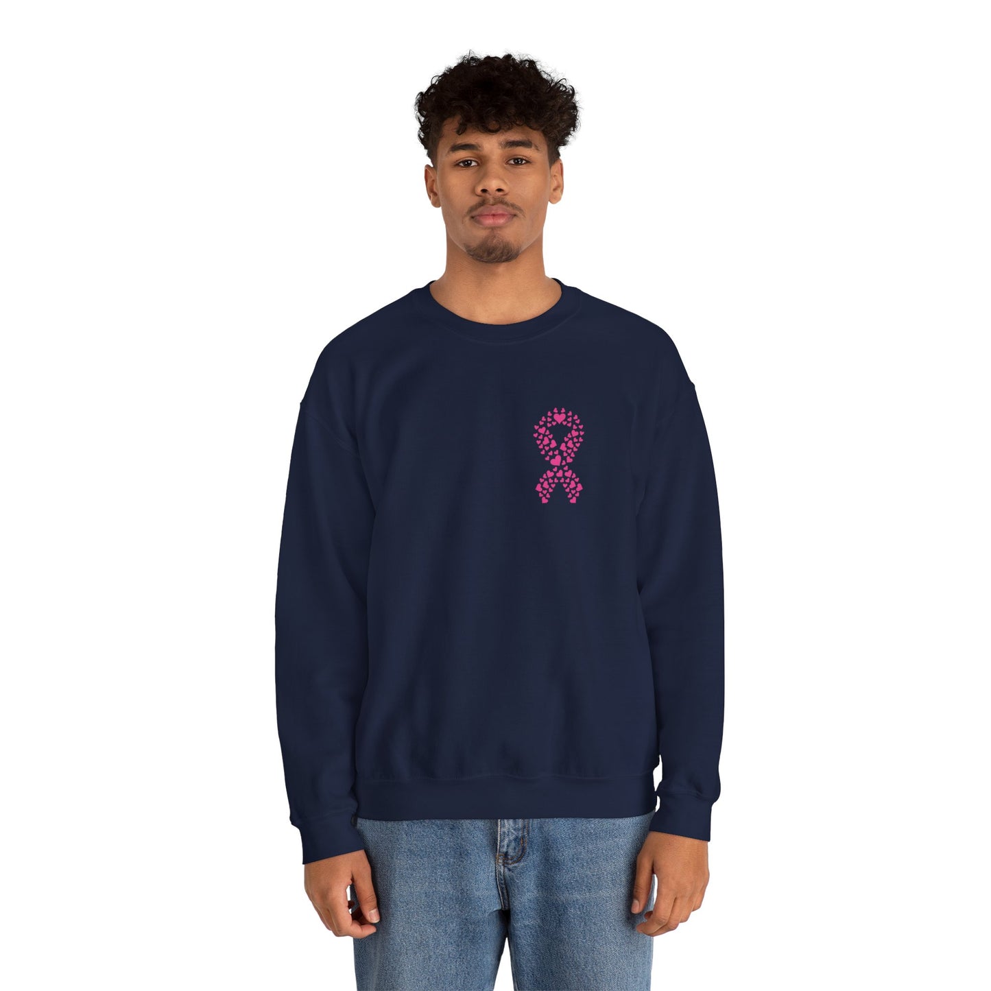 Man wearing navy blue breast cancer awareness crewneck sweatshirt featuring pink heart-pattern ribbon graphic, Makin’ It by Lady Ev.
