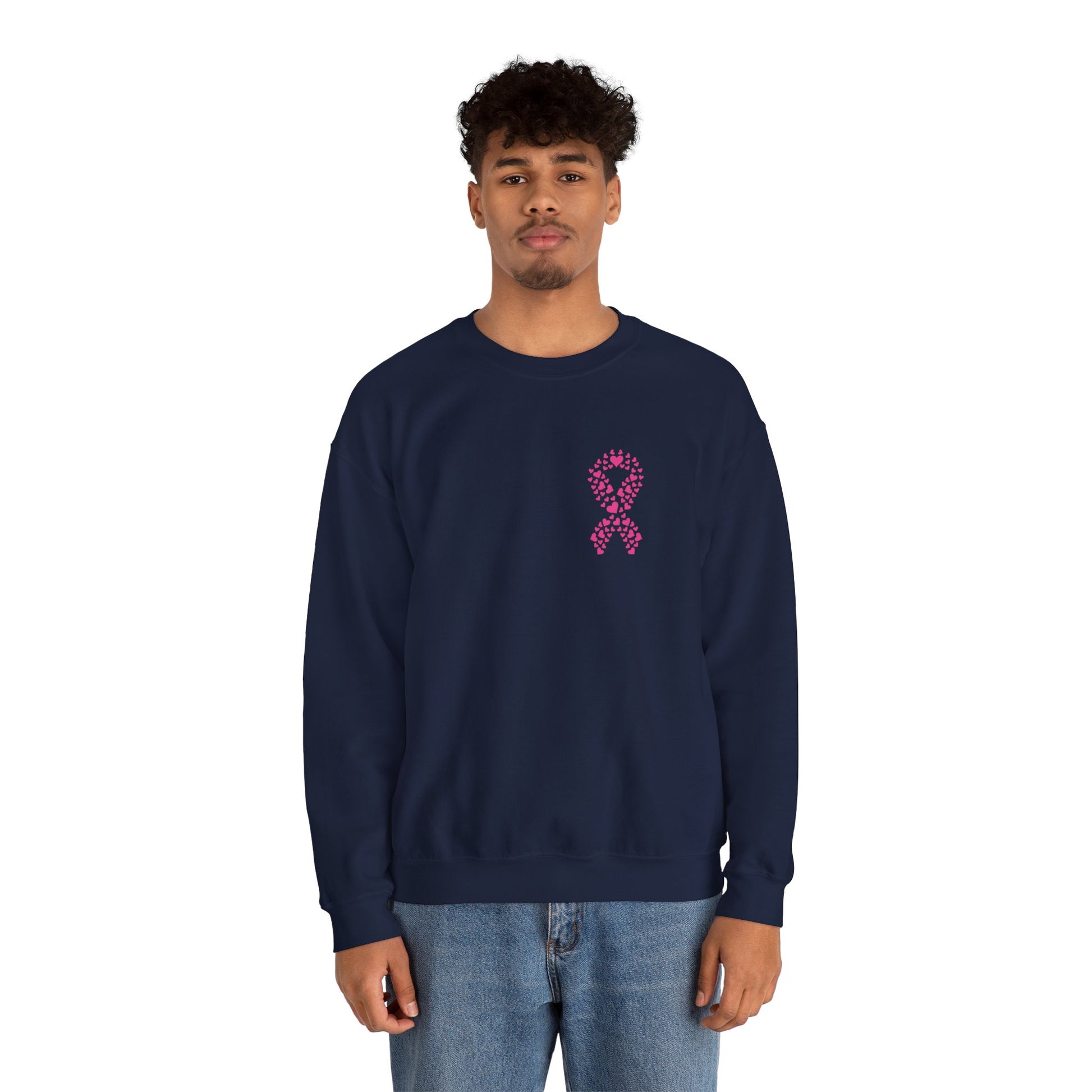 Man wearing navy blue breast cancer awareness crewneck sweatshirt featuring pink heart-pattern ribbon graphic, Makin’ It by Lady Ev.