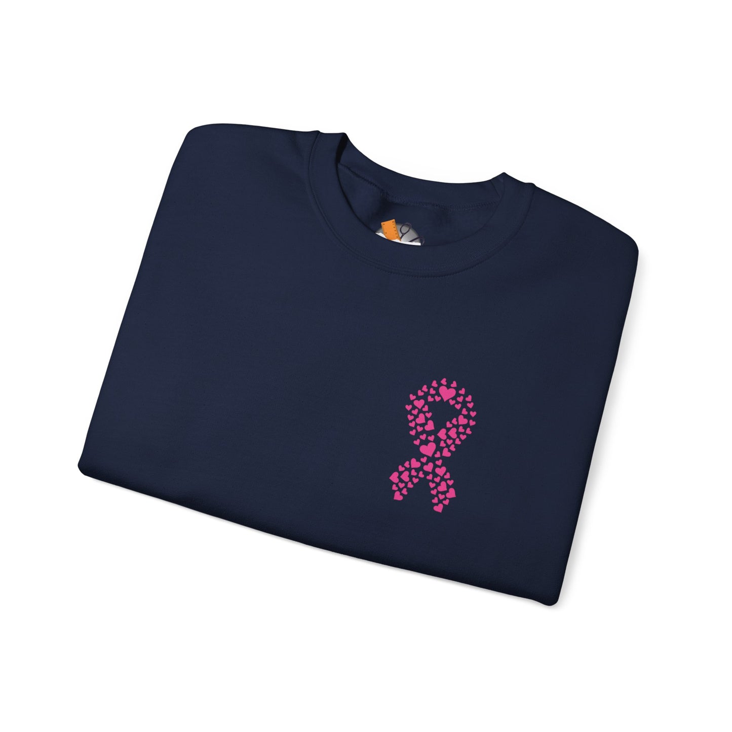 Folded navy blue crewneck sweatshirt with pink ribbon made of hearts design supporting breast cancer awareness, Makin’ It by Lady Ev.
