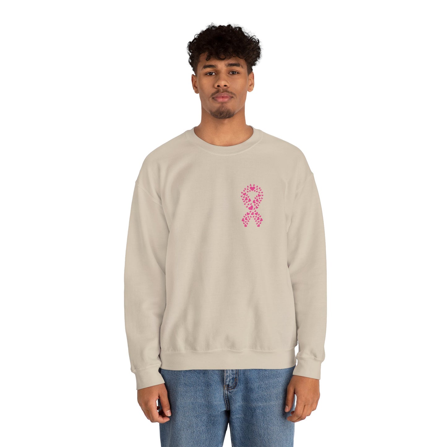 Man wearing sand-colored breast cancer awareness crewneck sweatshirt featuring pink ribbon made of hearts, Makin’ It by Lady Ev.