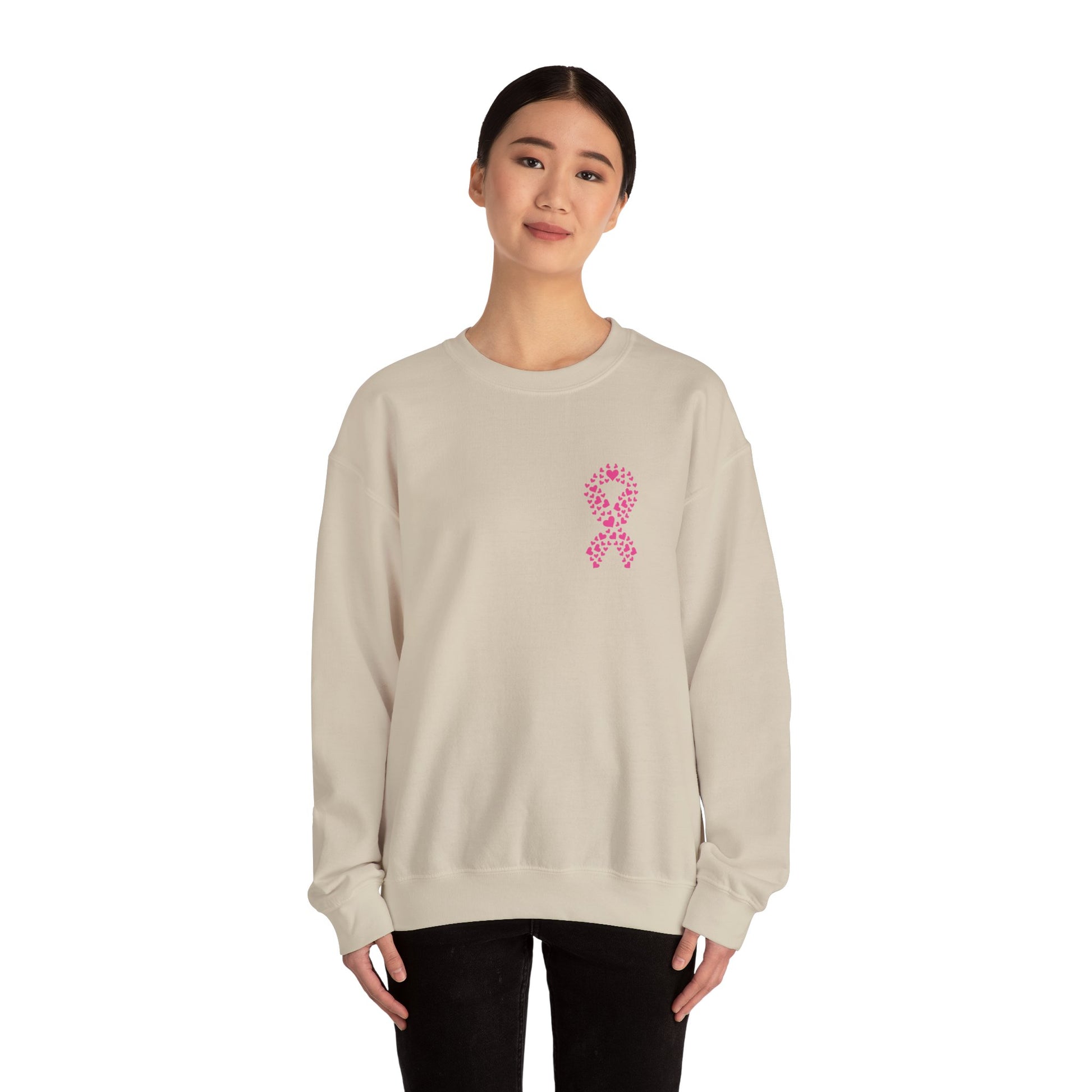 Woman wearing sand breast cancer awareness crewneck sweatshirt with pink ribbon made of hearts, Makin’ It by Lady Ev.