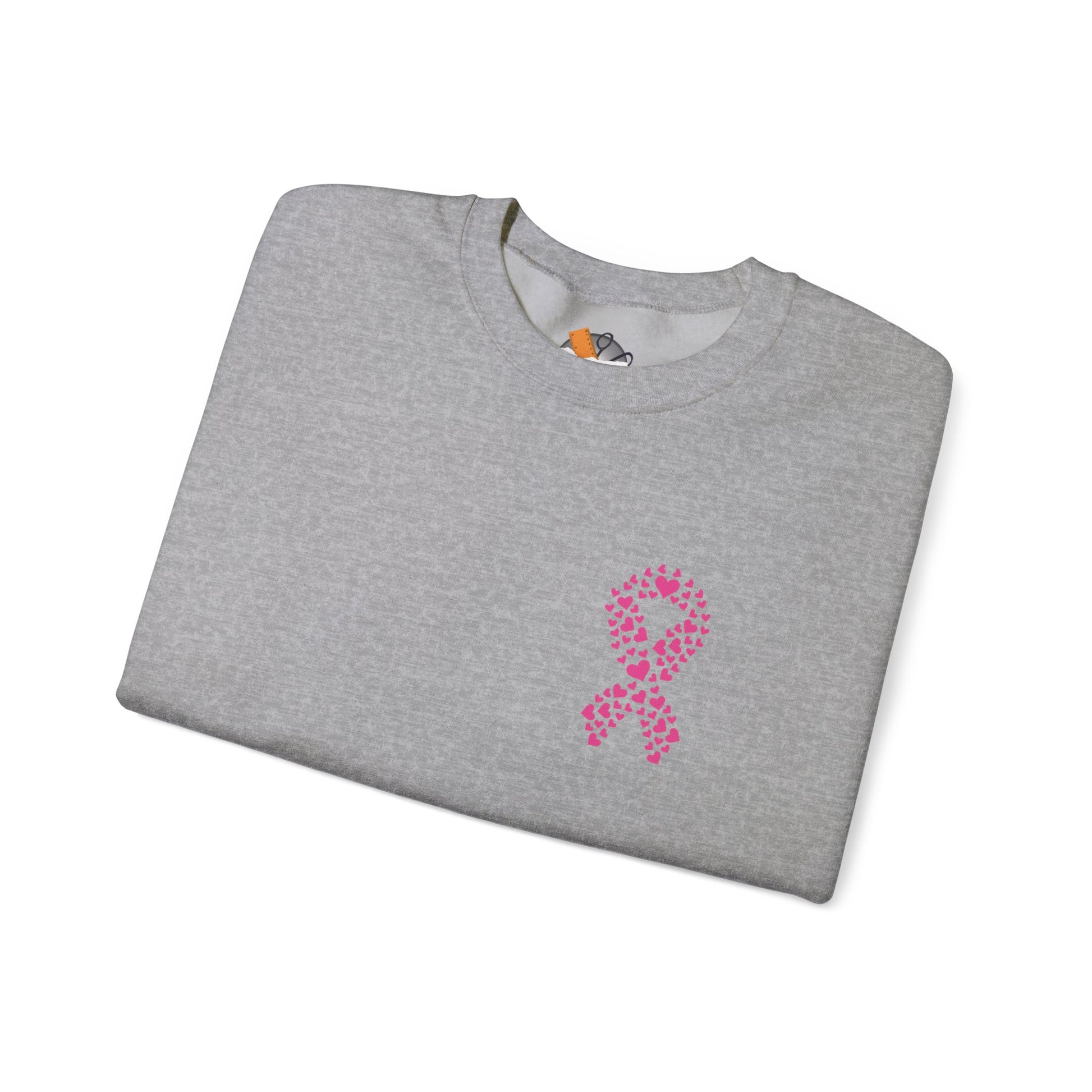 Folded sport gray crewneck sweatshirt with pink ribbon of hearts design supporting breast cancer awareness, Makin’ It by Lady Ev.