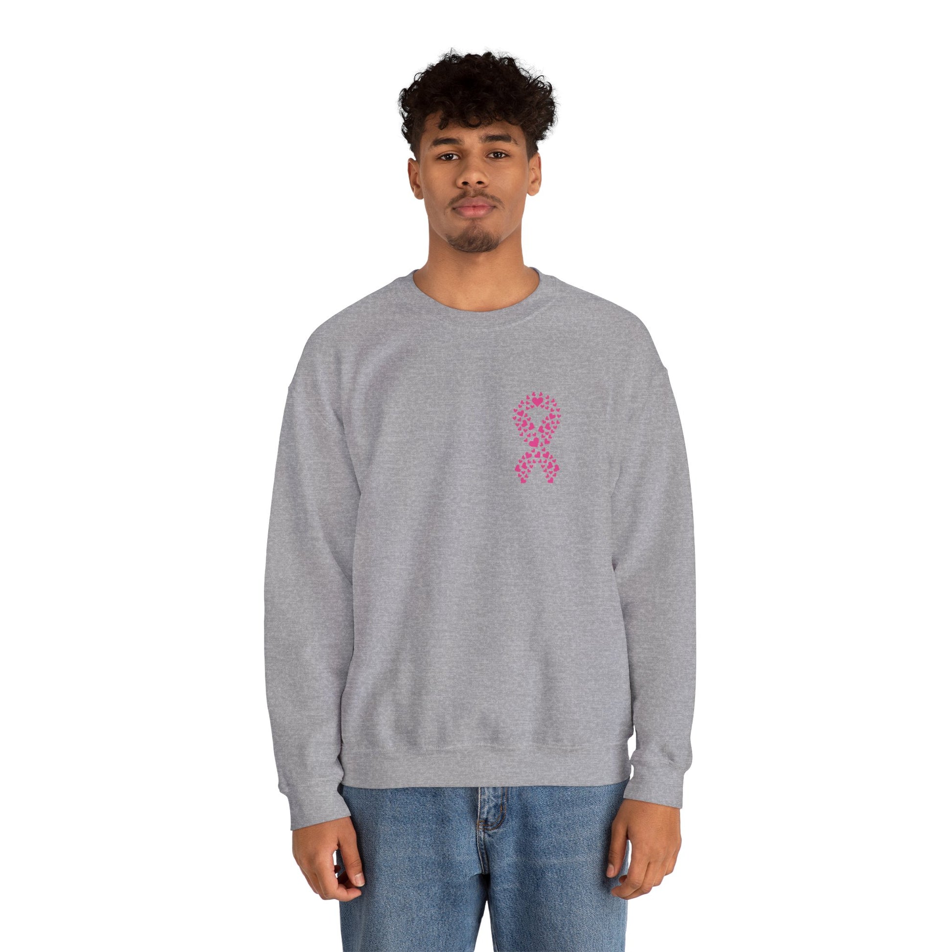 Man wearing sport gray breast cancer awareness crewneck sweatshirt with pink heart ribbon design, Makin’ It by Lady Ev.