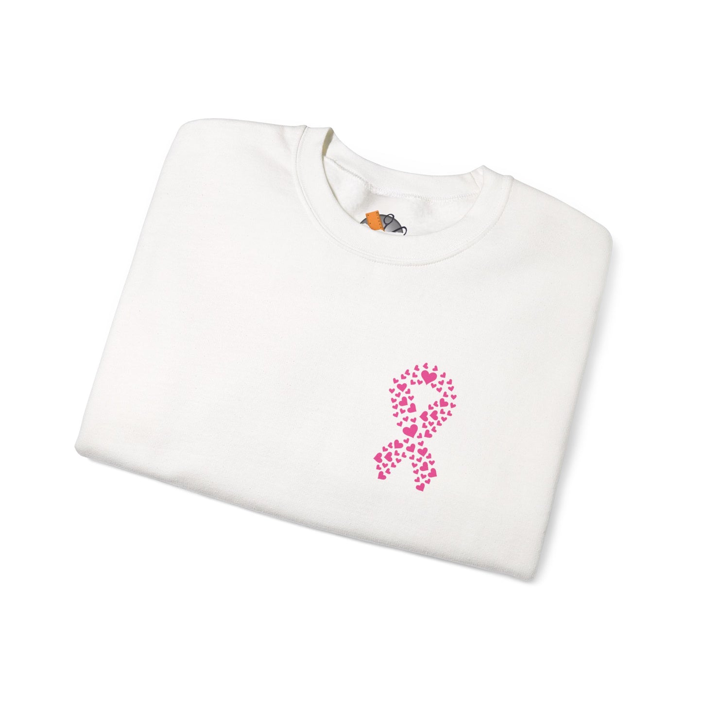 Folded white crewneck sweatshirt featuring pink heart-shaped ribbon design for breast cancer awareness, Makin’ It by Lady Ev.