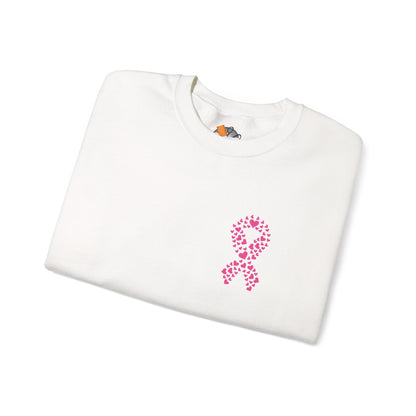 Folded white crewneck sweatshirt featuring pink heart-shaped ribbon design for breast cancer awareness, Makin’ It by Lady Ev.