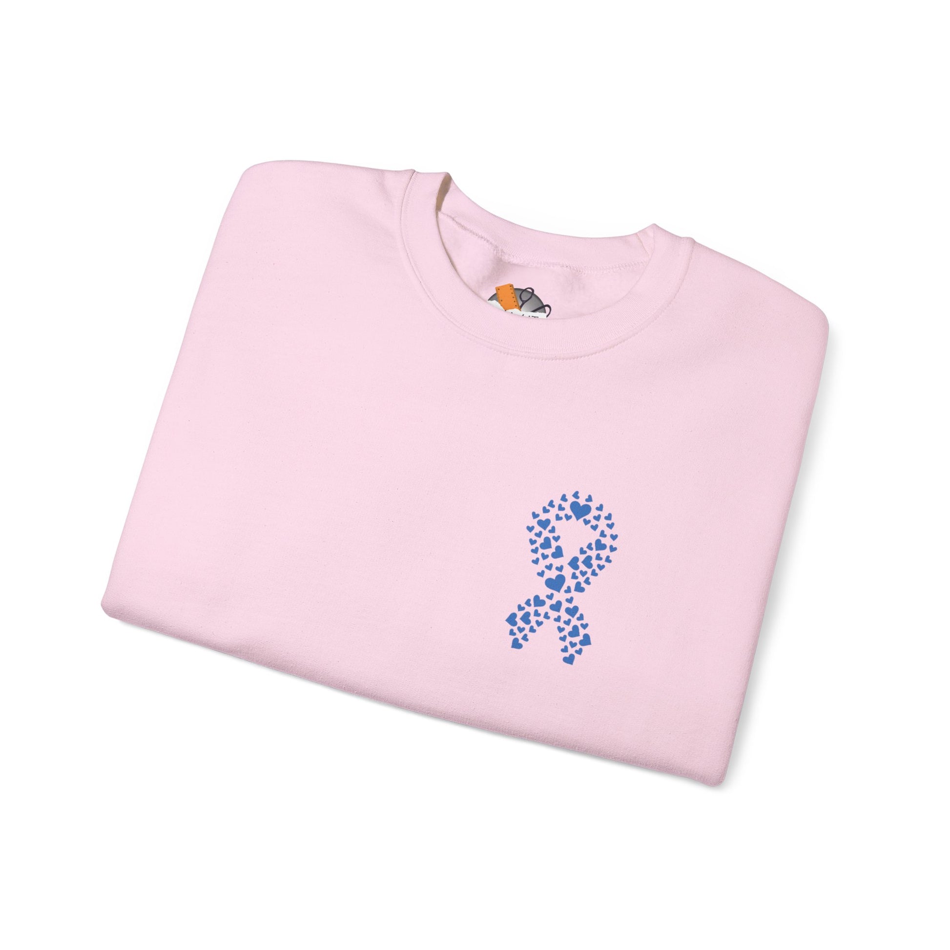 Folded light pink diabetes awareness sweatshirt featuring blue heart ribbon — cozy unisex crewneck for support and solidarity.