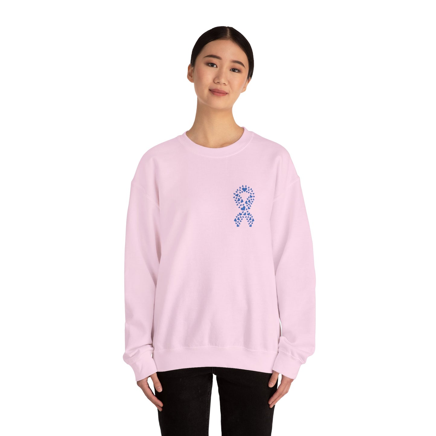 Woman wearing light pink diabetes awareness crewneck sweatshirt with blue heart ribbon — soft, stylish, and supportive apparel.