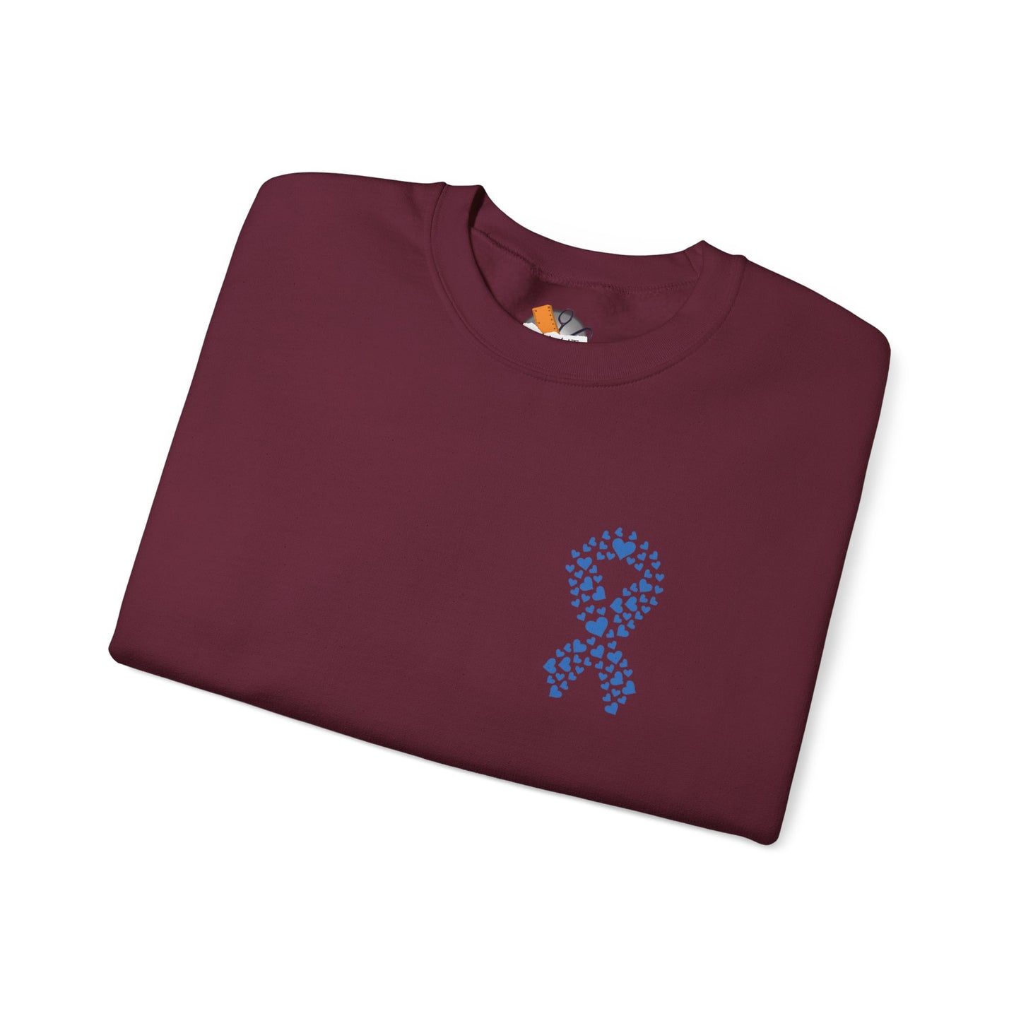 Folded maroon diabetes awareness sweatshirt featuring blue heart ribbon — soft unisex crewneck supporting diabetes awareness.