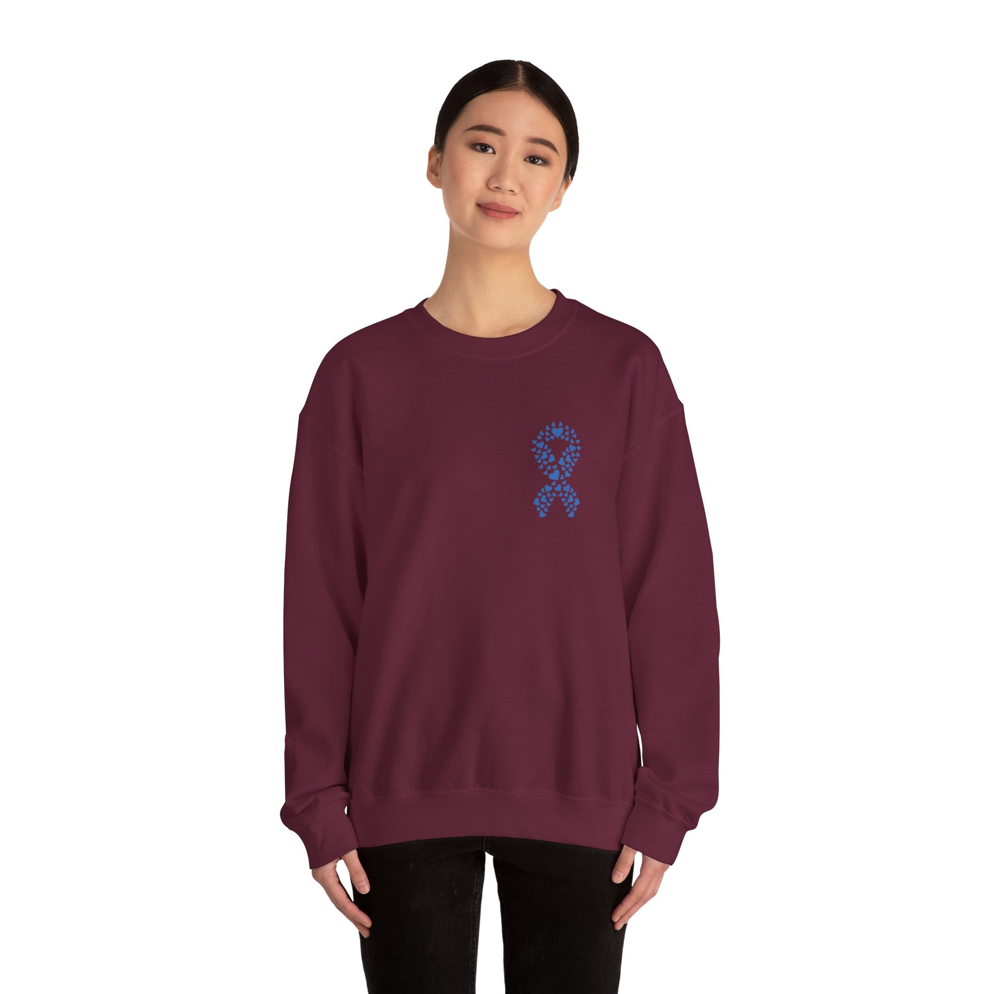 Woman wearing maroon diabetes awareness crewneck sweatshirt with blue heart ribbon — stylish unisex fleece spreading awareness and support.