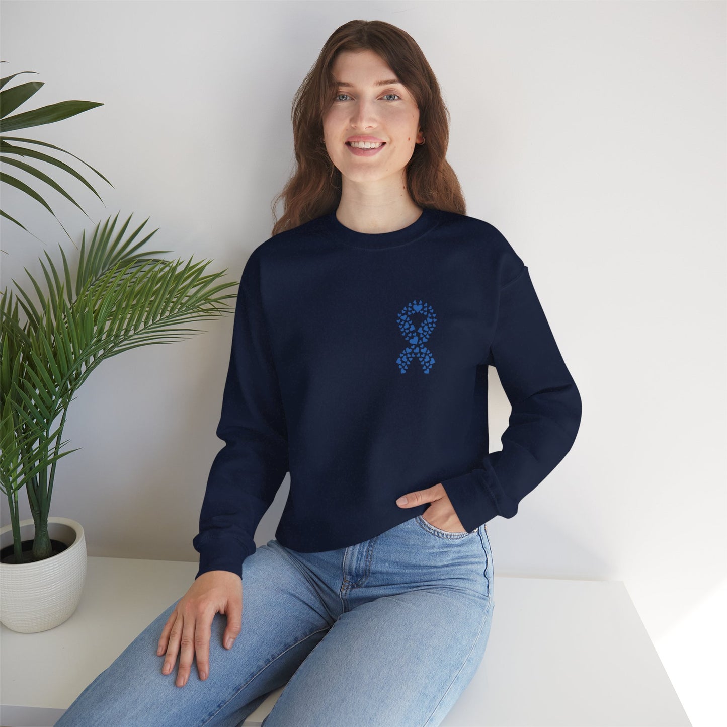 Smiling woman wearing navy blue diabetes awareness crewneck indoors — cozy fall sweatshirt supporting diabetes awareness and unity.