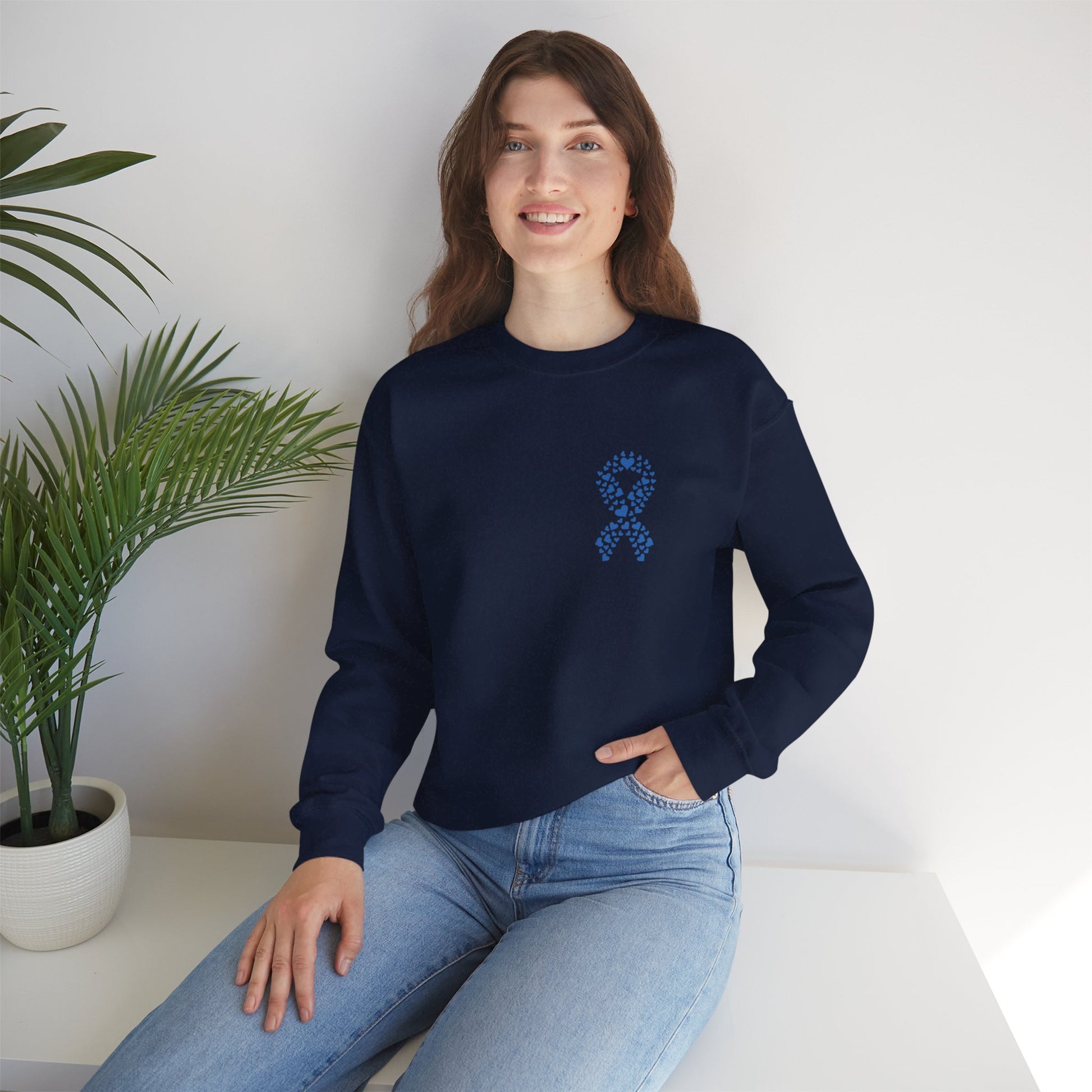Smiling woman wearing navy blue diabetes awareness crewneck indoors — cozy fall sweatshirt supporting diabetes awareness and unity.