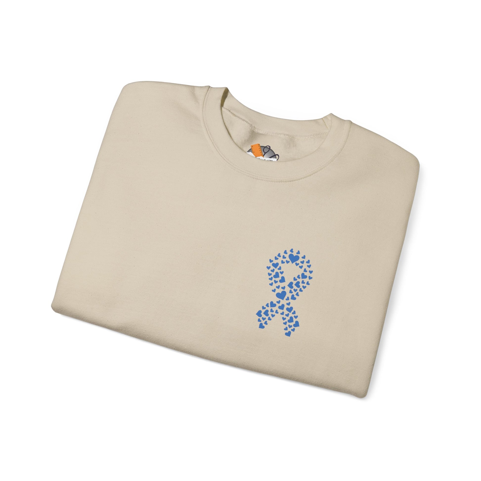 Folded sand diabetes awareness sweatshirt featuring blue heart ribbon — soft unisex crewneck for awareness and advocacy.