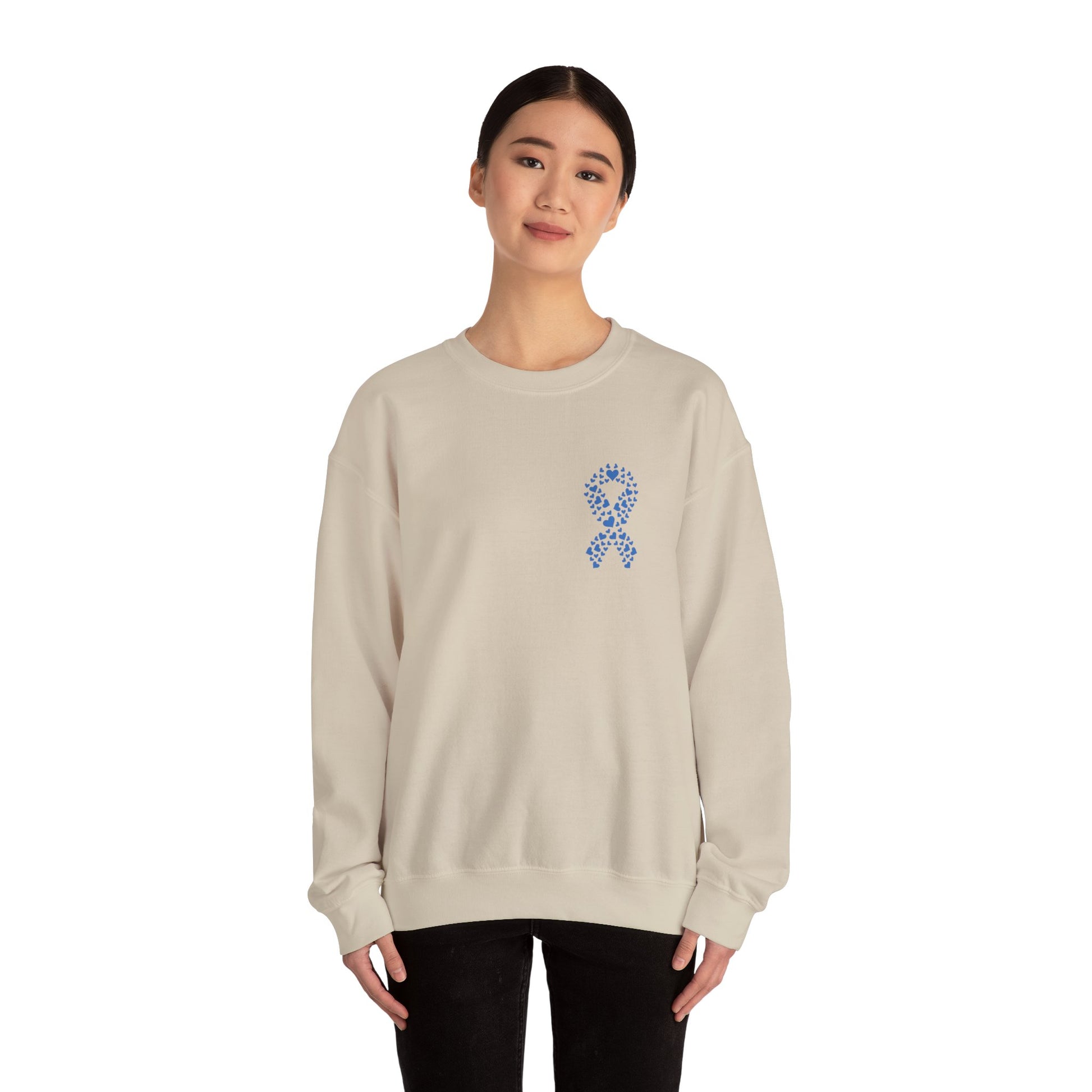 Woman wearing sand diabetes awareness crewneck sweatshirt with blue heart ribbon — comfortable unisex fleece promoting diabetes awareness.