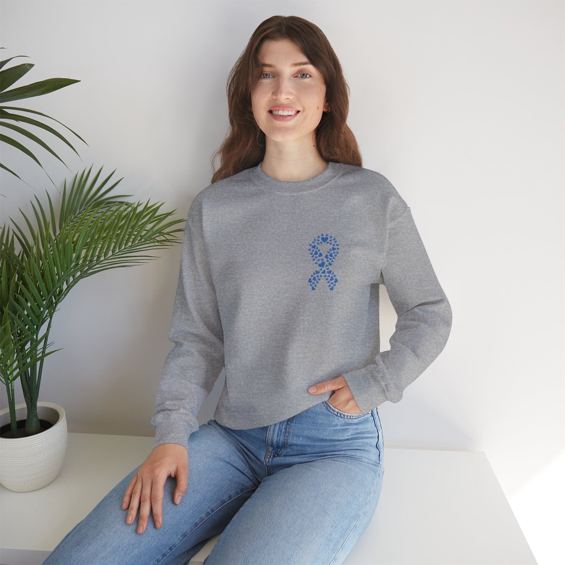 Smiling woman wearing sport grey diabetes awareness crewneck indoors — soft unisex sweatshirt supporting diabetes awareness and care.