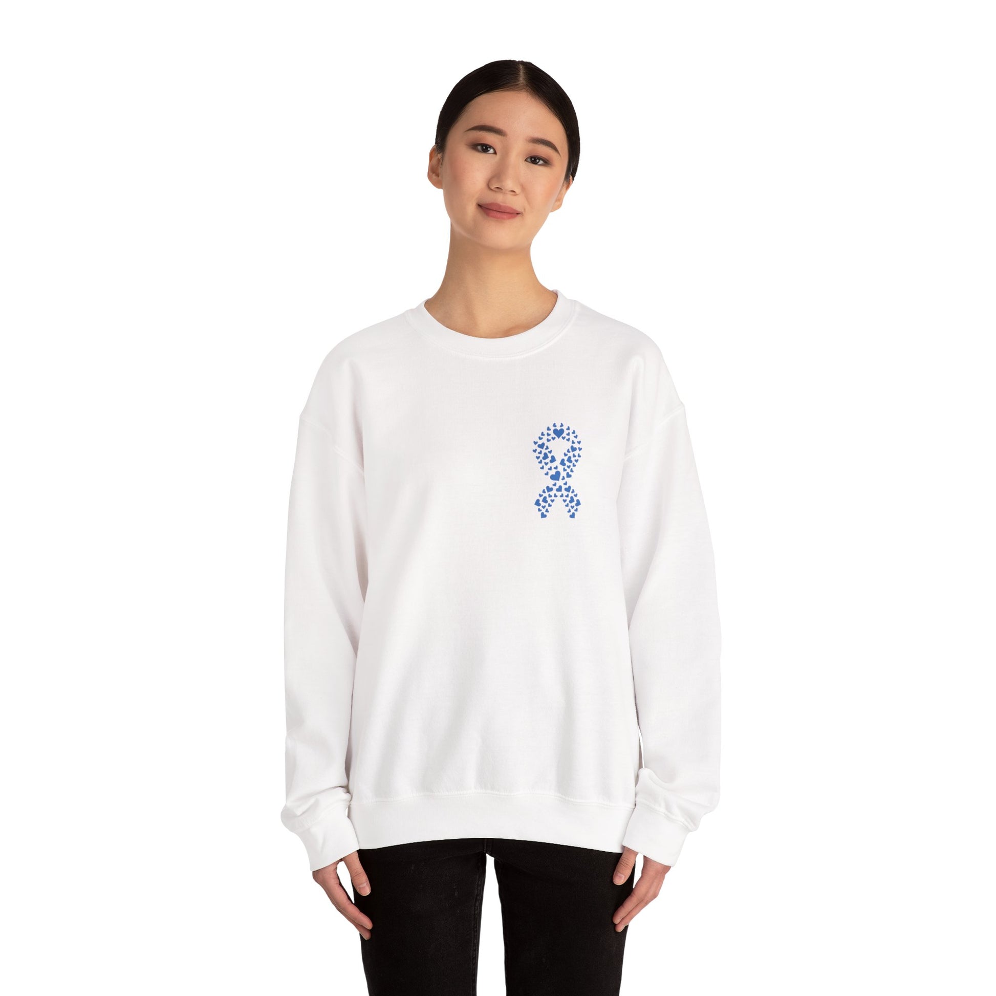 Woman wearing white diabetes awareness crewneck sweatshirt with blue heart ribbon — clean and classic unisex design promoting awareness.