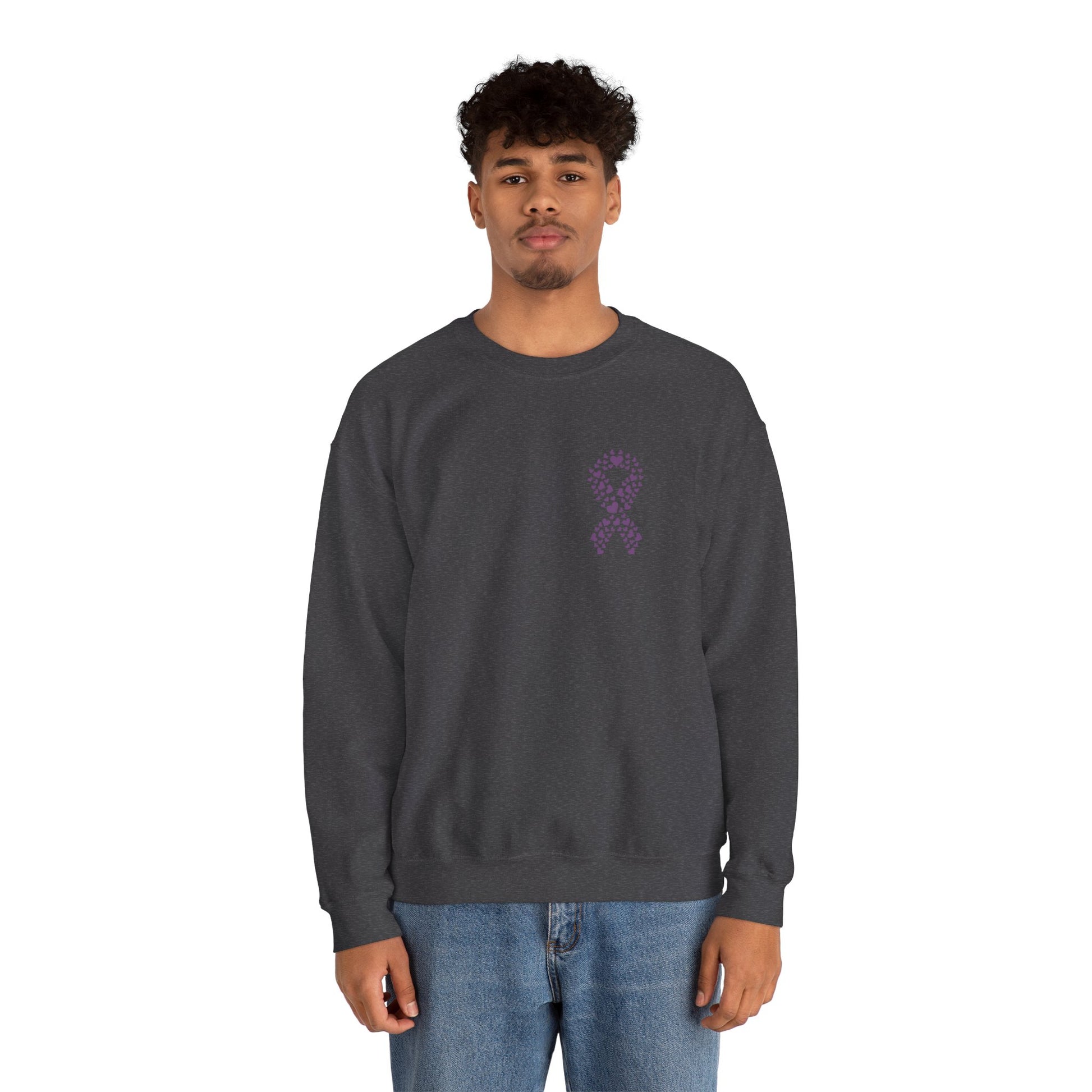 Man wearing charcoal gray domestic violence awareness crewneck sweatshirt featuring purple ribbon heart graphic, Makin’ It by Lady Ev.