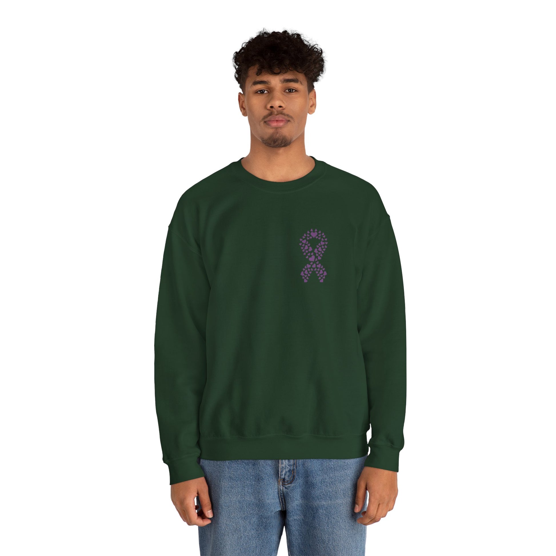 Man wearing forest green domestic violence awareness crewneck sweatshirt featuring purple heart ribbon graphic, Makin’ It by Lady Ev.
