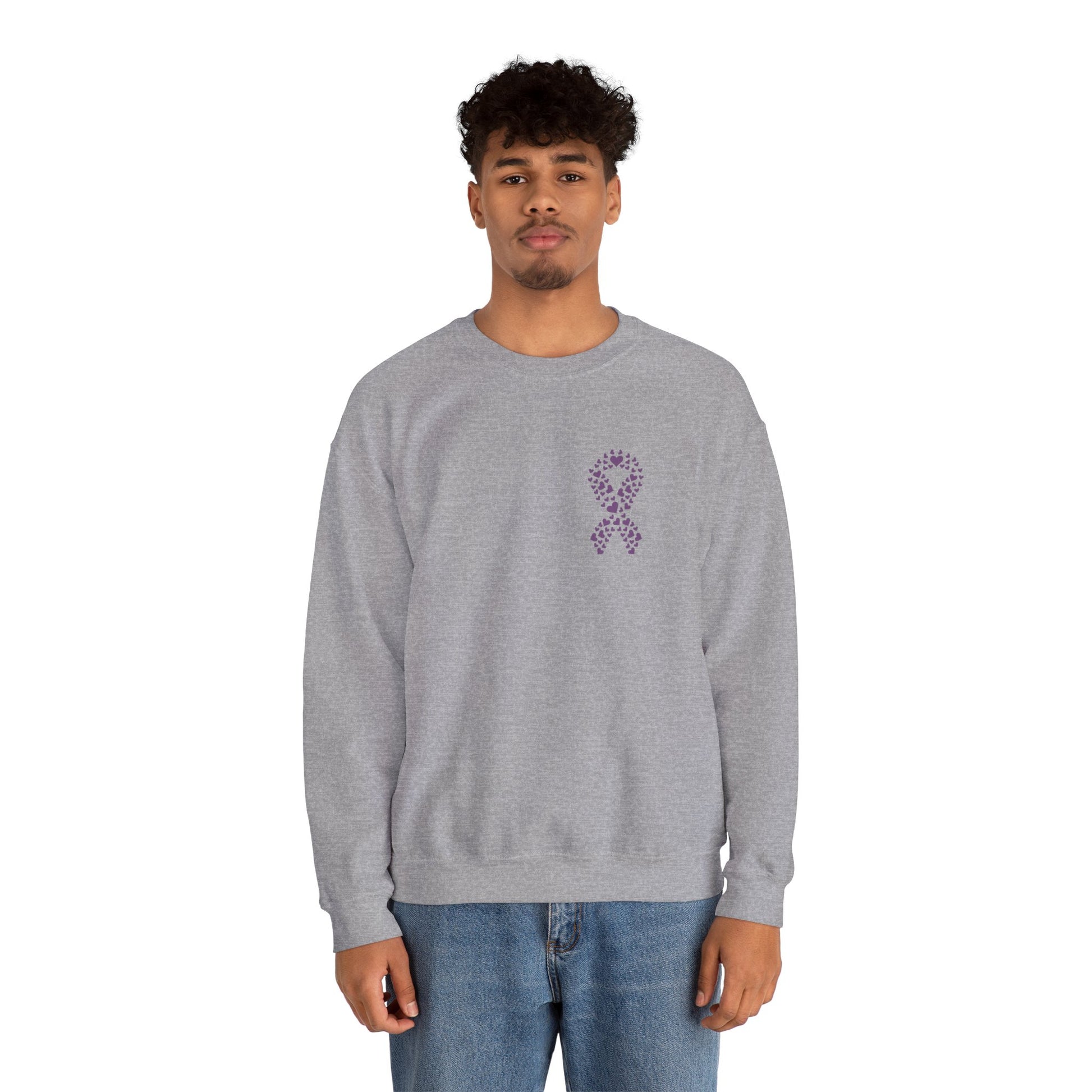 Man wearing heather gray domestic violence awareness crewneck sweatshirt featuring purple ribbon heart graphic, Makin’ It by Lady Ev.