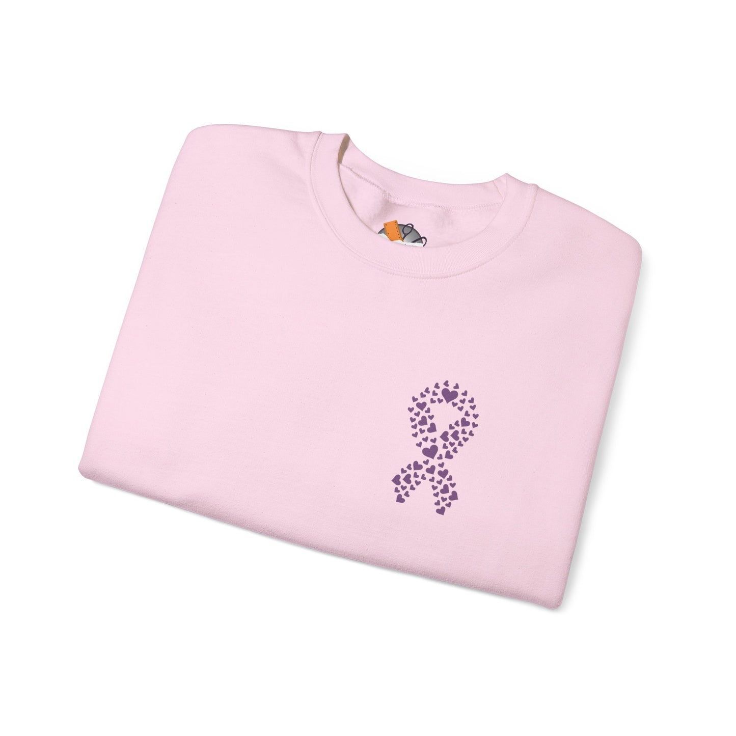 Folded pink crewneck sweatshirt featuring purple heart-shaped ribbon design supporting domestic violence awareness, Makin’ It by Lady Ev.