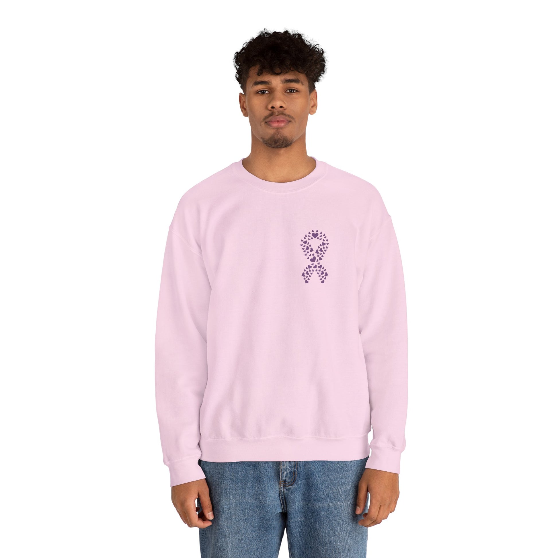Man wearing pink domestic violence awareness crewneck sweatshirt featuring purple ribbon heart design, Makin’ It by Lady Ev.