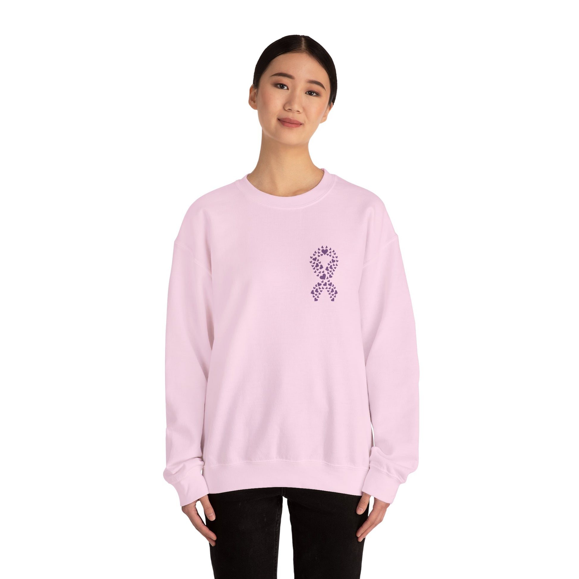 Woman wearing pink domestic violence awareness crewneck sweatshirt with purple ribbon made of hearts, Makin’ It by Lady Ev.
