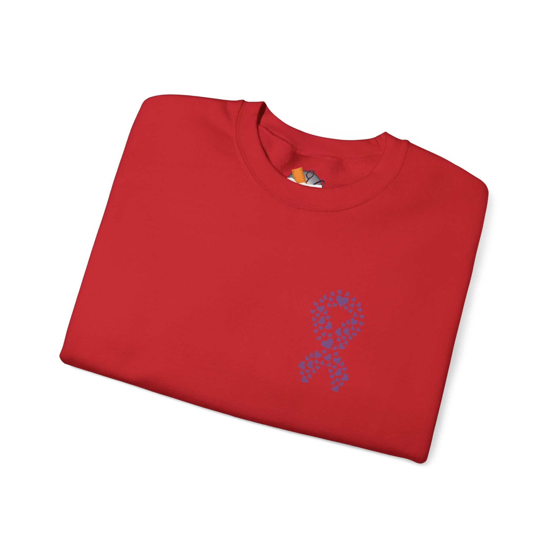 Folded red crewneck sweatshirt featuring purple heart ribbon design promoting domestic violence awareness, Makin’ It by Lady Ev.