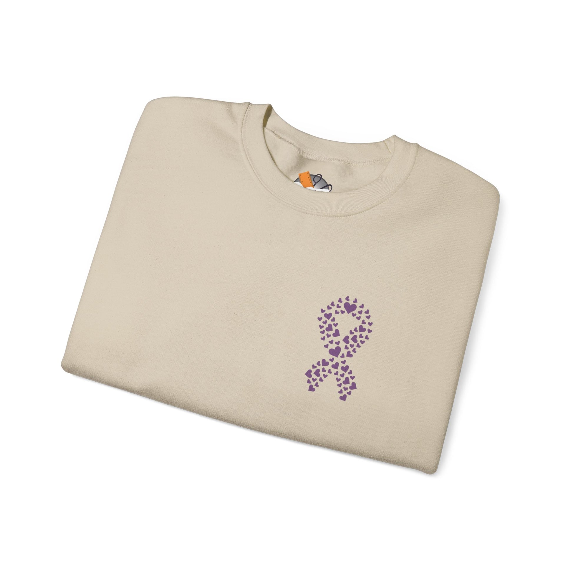 Folded sand crewneck sweatshirt featuring purple heart-shaped ribbon design for domestic violence awareness, Makin’ It by Lady Ev.