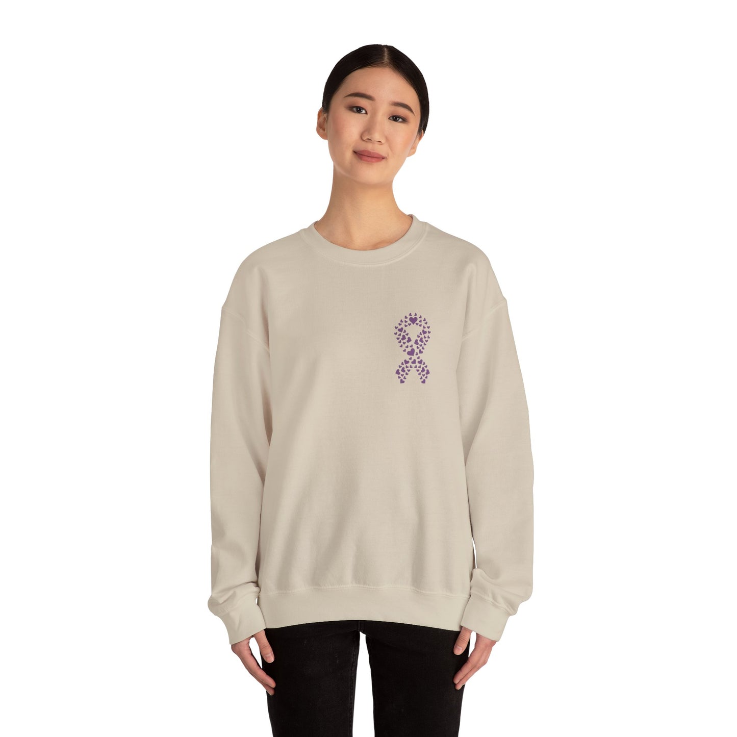 Woman wearing sand domestic violence awareness crewneck sweatshirt with purple ribbon heart design, Makin’ It by Lady Ev.